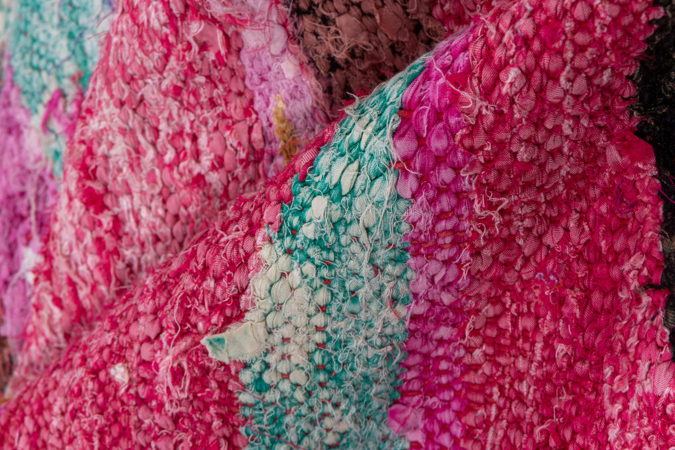 4' x 7' one-of-a-kind handmade vintage Rag Rug rug. Color palette: magenta, purple, pink, brown, turquoise, ivory, navy