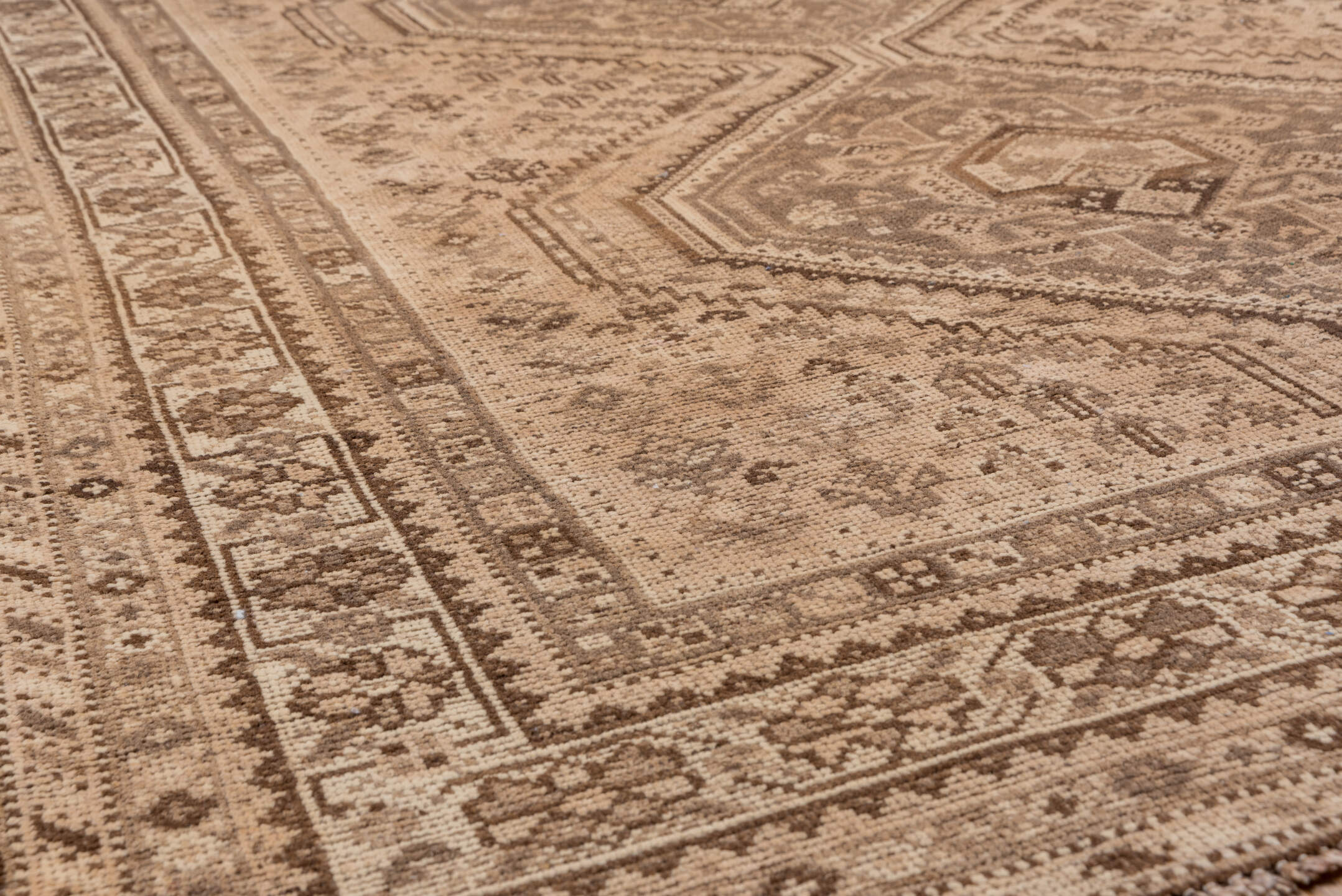5' x 6' one-of-a-kind handmade antique Shiraz rug. Color palette: camel, taupe, brown, beige, ivory, gray