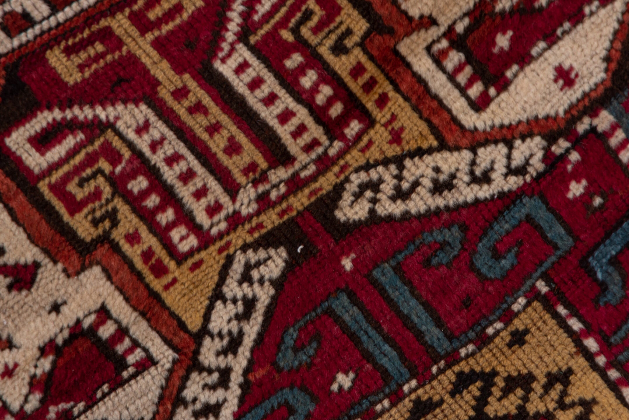 4' x 10' one-of-a-kind handmade vintage Caucasian runner rug. Color palette: black, blue, brown, dim gray, gray, pink, red