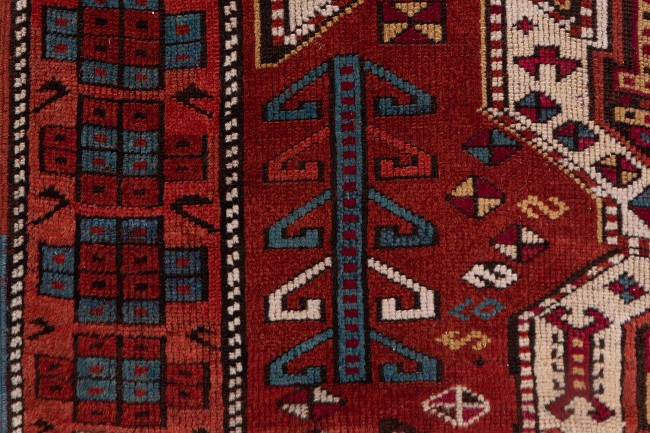 4' x 10' one-of-a-kind handmade antique Caucasian runner rug. Color palette: rust, ivory, indigo, crimson, sky_blue, gold