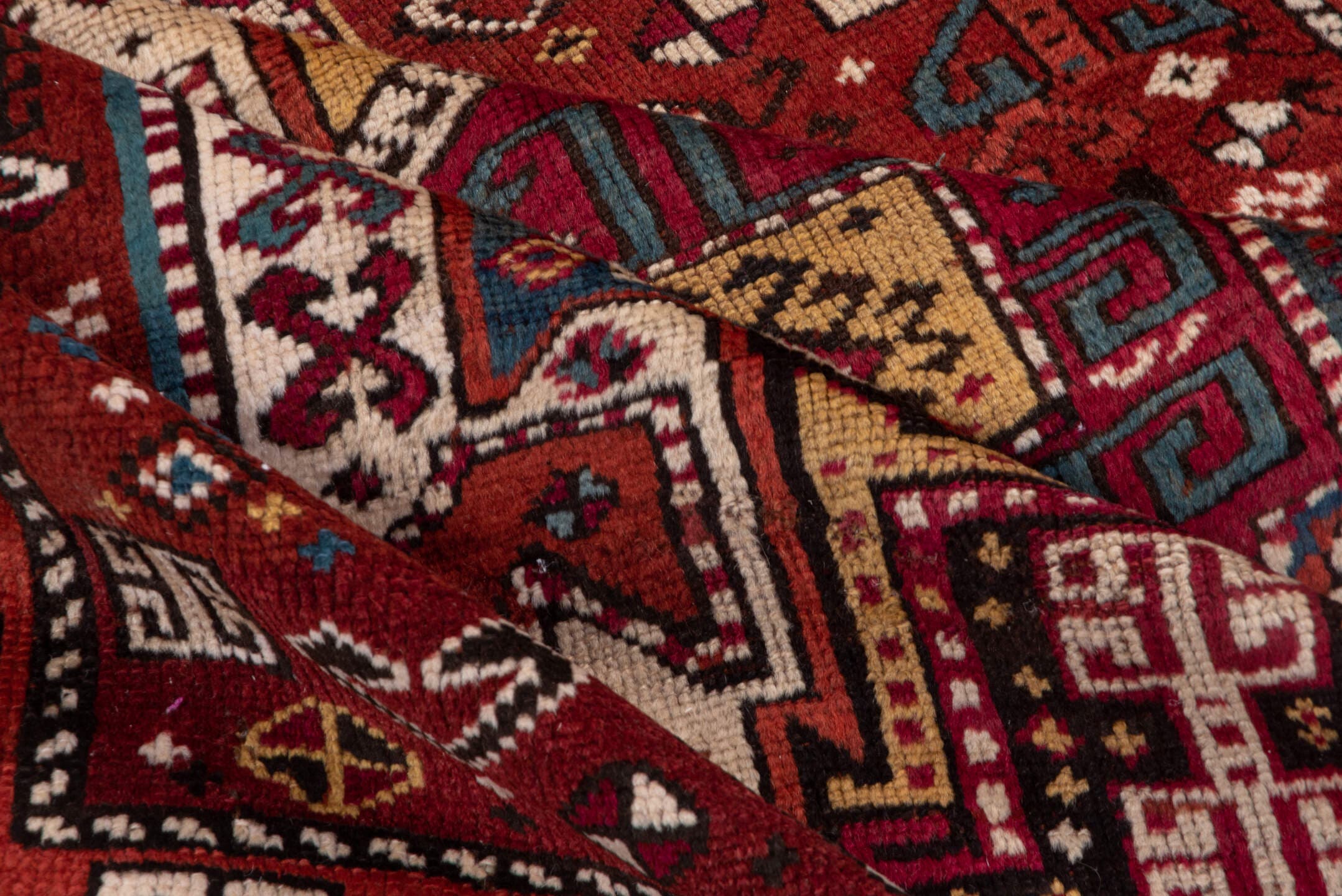 4' x 10' one-of-a-kind handmade antique Caucasian runner rug. Color palette: rust, ivory, indigo, crimson, sky_blue, gold