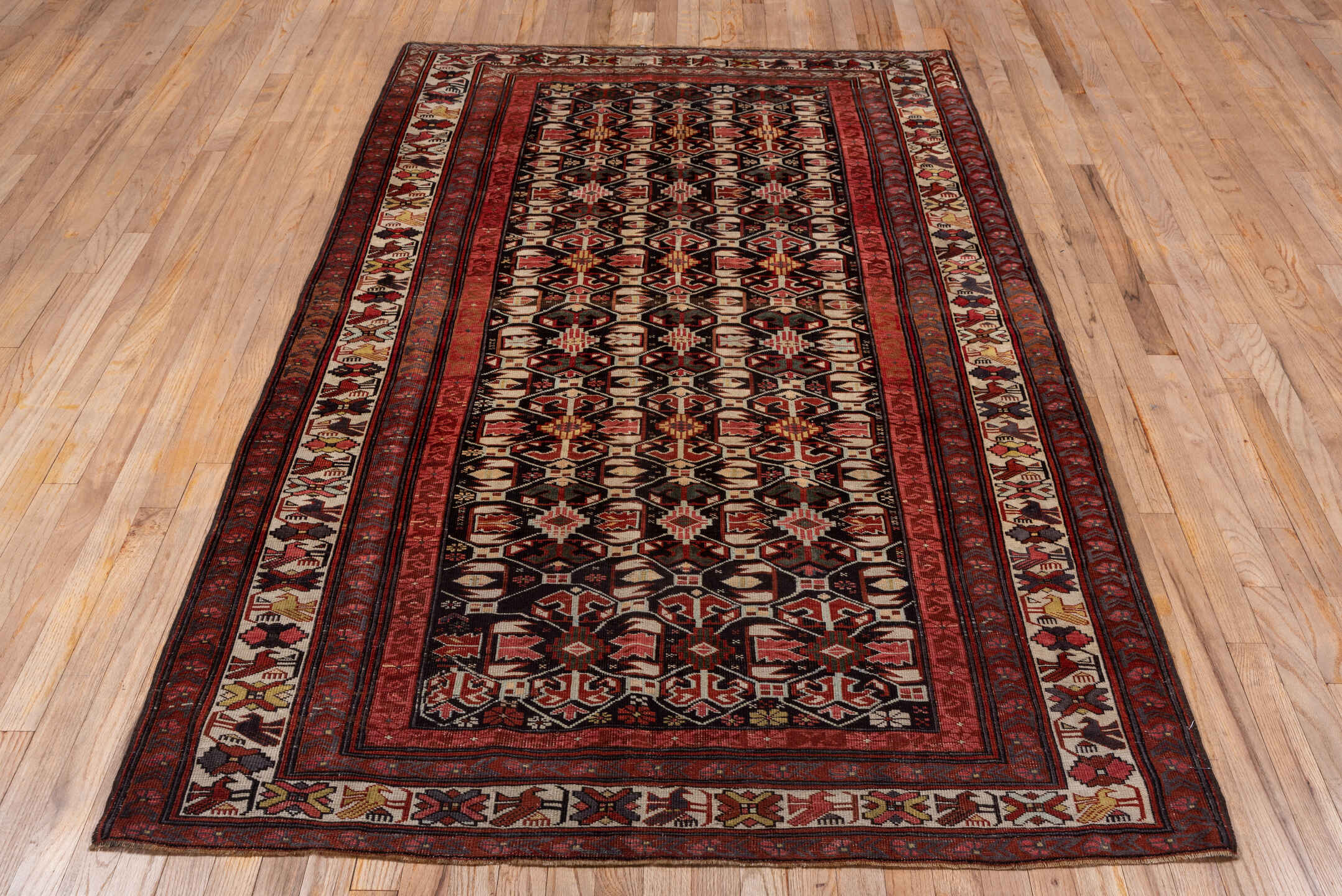 4' x 7' one-of-a-kind handmade vintage Kuba rug. Color palette: black, brown, gray, pink, red