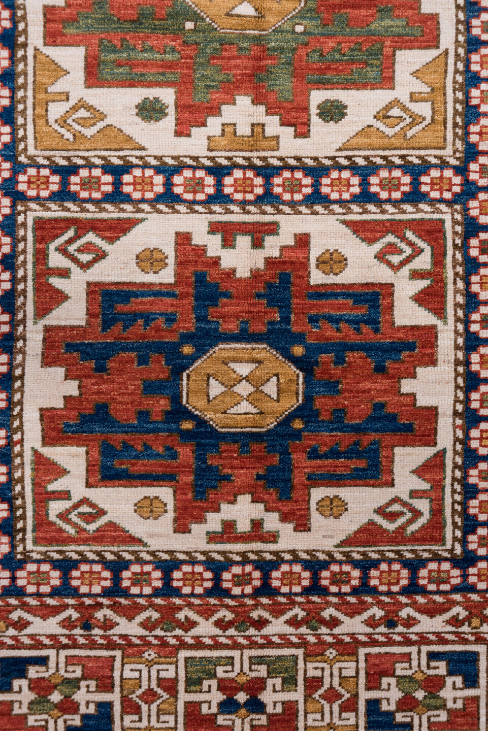 4' x 7' one-of-a-kind handmade vintage Kazak rug. Color palette: ivory, rust, indigo, olive, gold, terra cotta, terracotta
