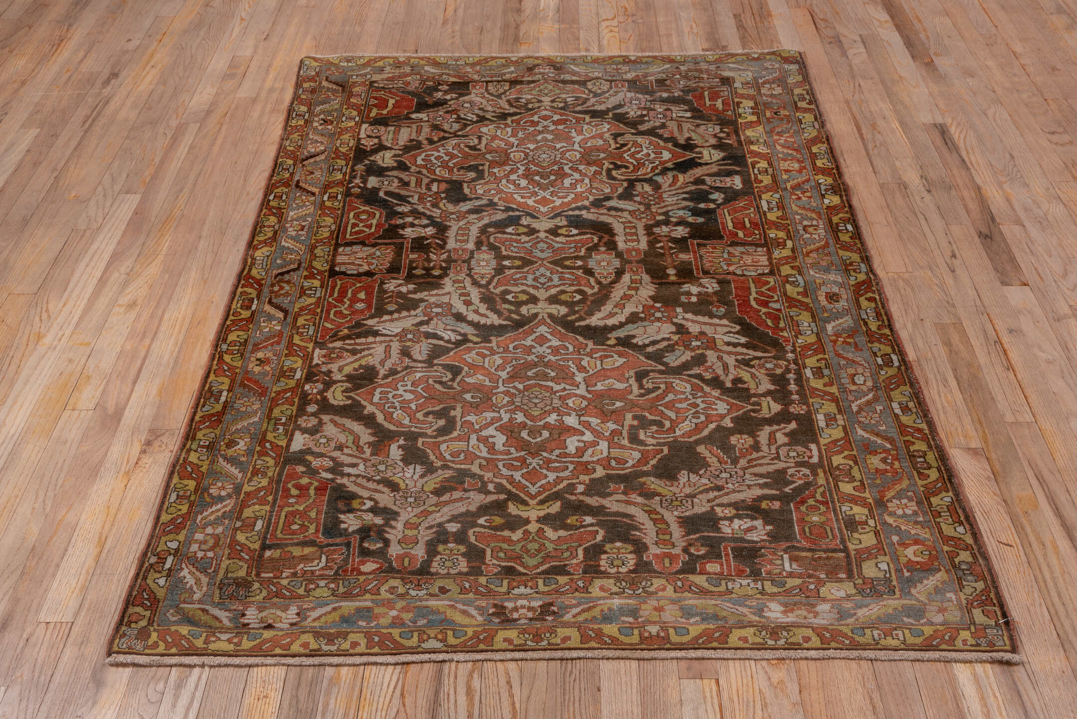 4' x 6' one-of-a-kind handmade antique Baktiary small size rug. Color palette: brown, rust, ivory, slate, camel, terra cotta