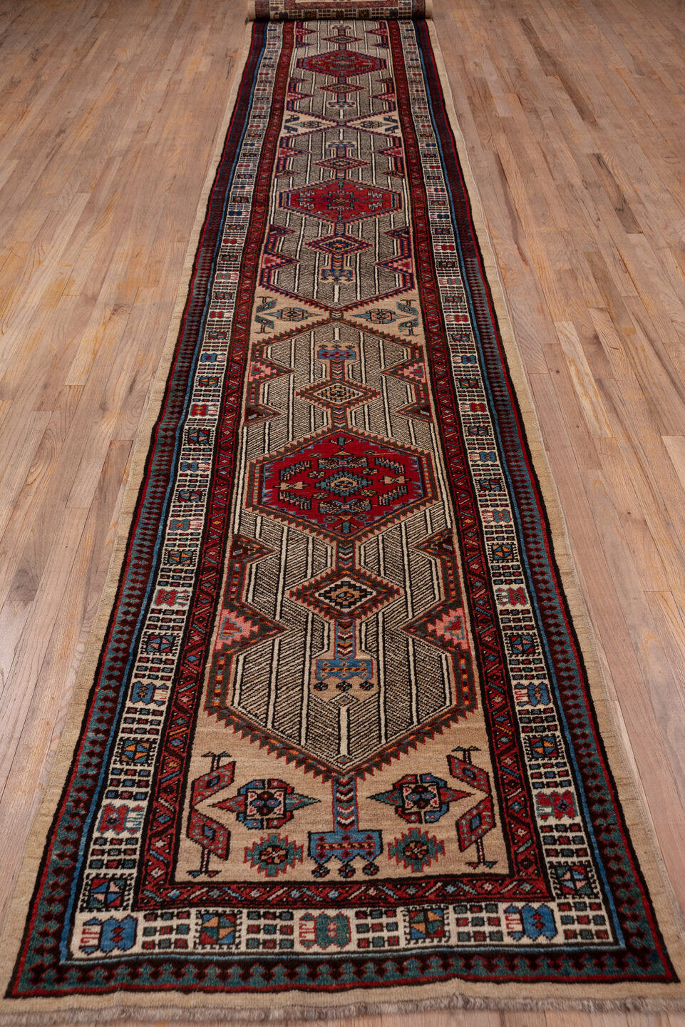 3' x 17' one-of-a-kind handmade vintage Sarab runner rug. Color palette: ivory, rust, indigo, soft_blue, brown, burgundy