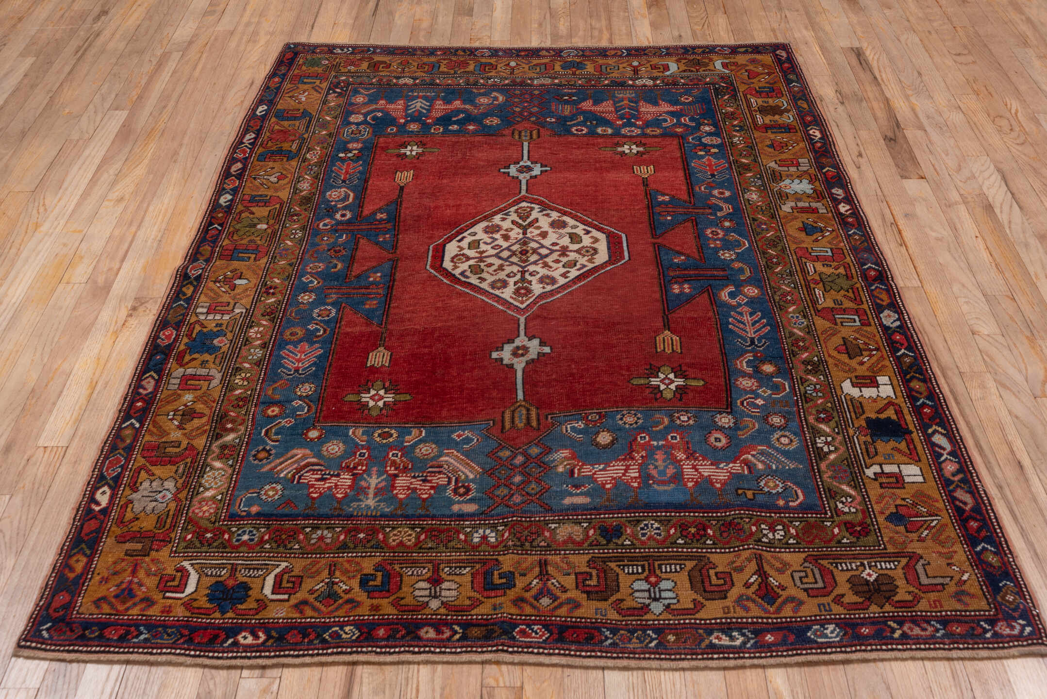 5' x 6' one-of-a-kind handmade vintage Caucasian rug. Color palette: blue, brown, gray, pink, red