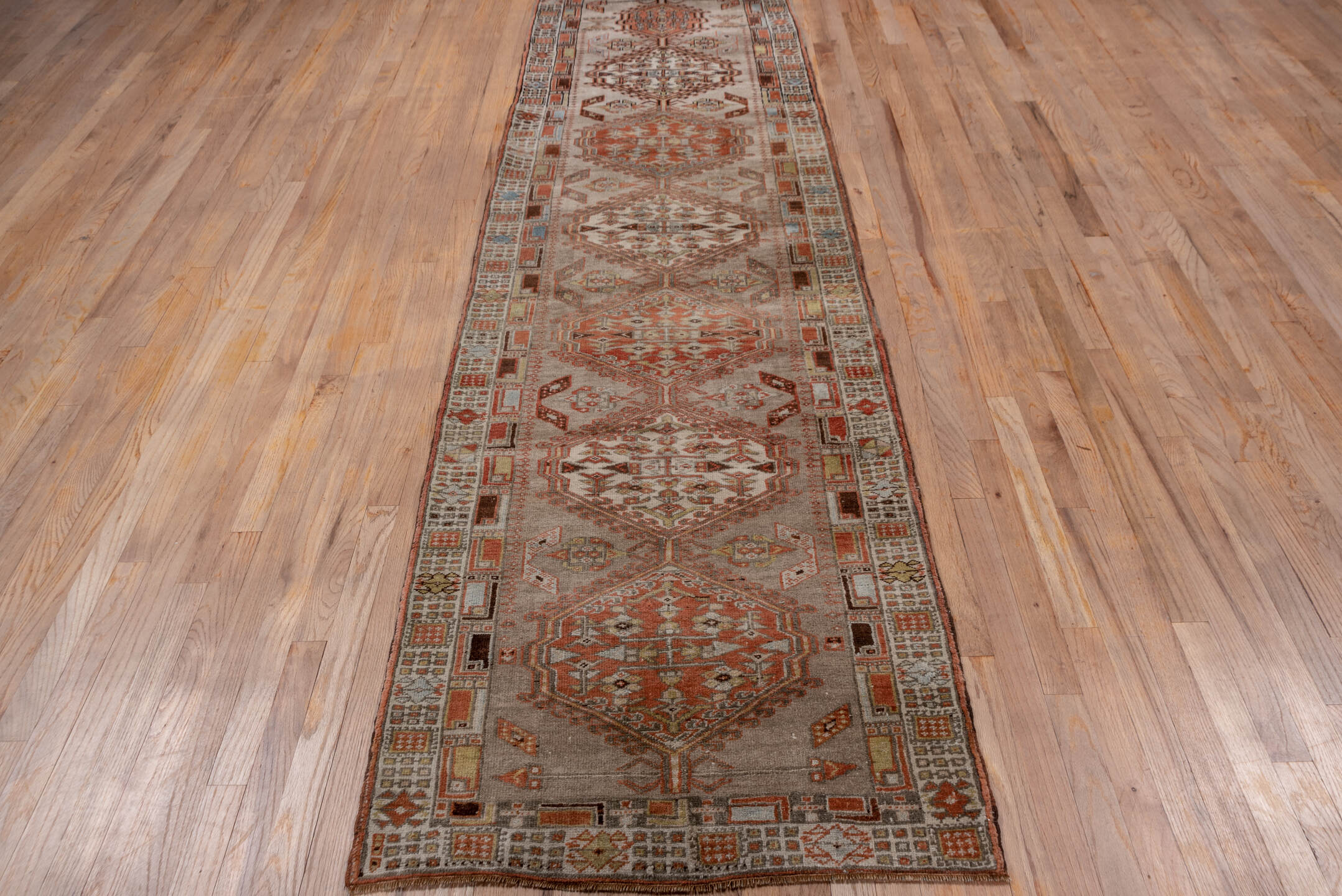 2' x 10' one-of-a-kind handmade antique Sarab runner rug. Color palette: taupe, rust, ivory, brown, pale blue, camel, beige