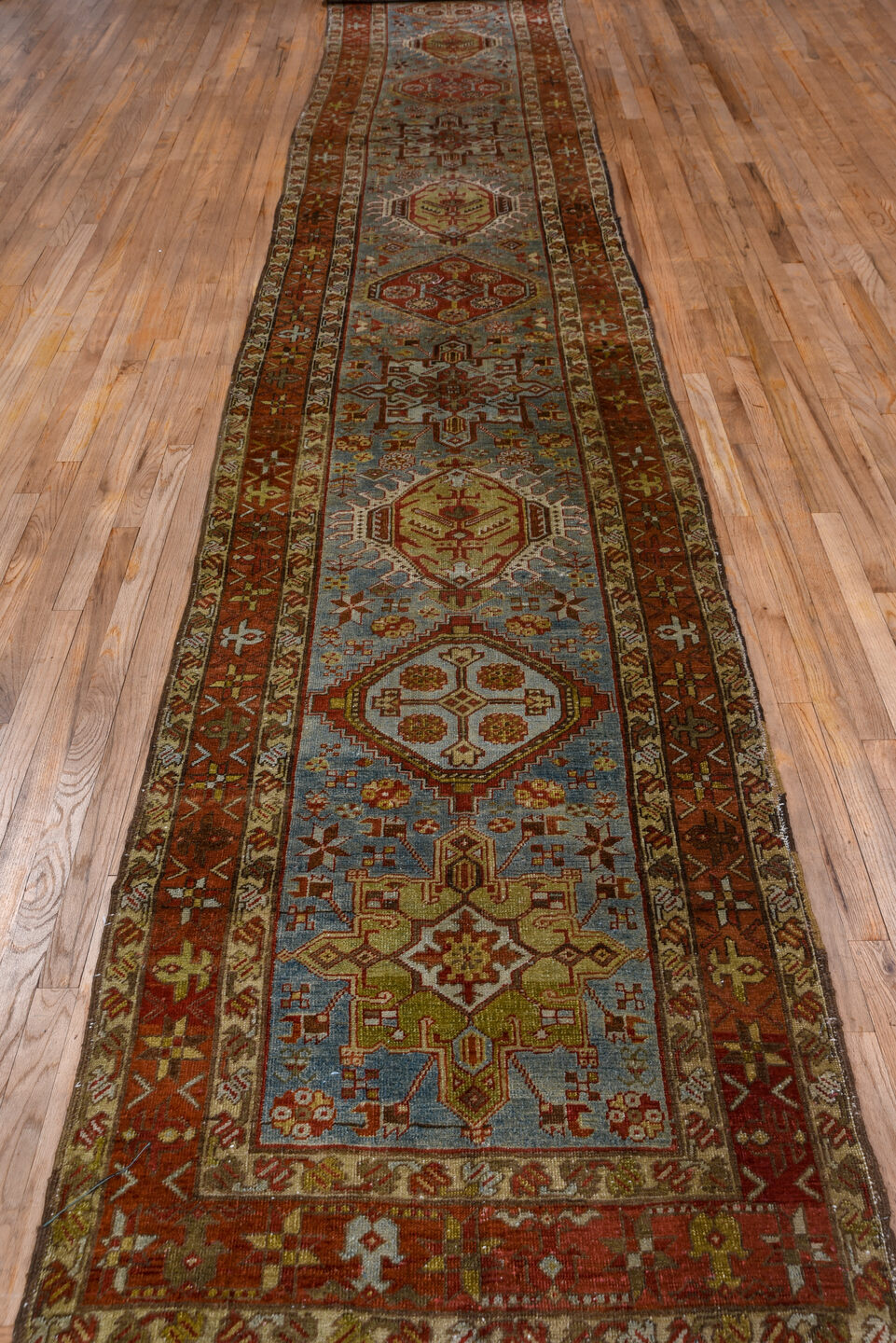 3' x 18' one-of-a-kind handmade antique Heriz runner rug. Color palette: rust, sky blue, ivory, brick, taupe, brown, slate