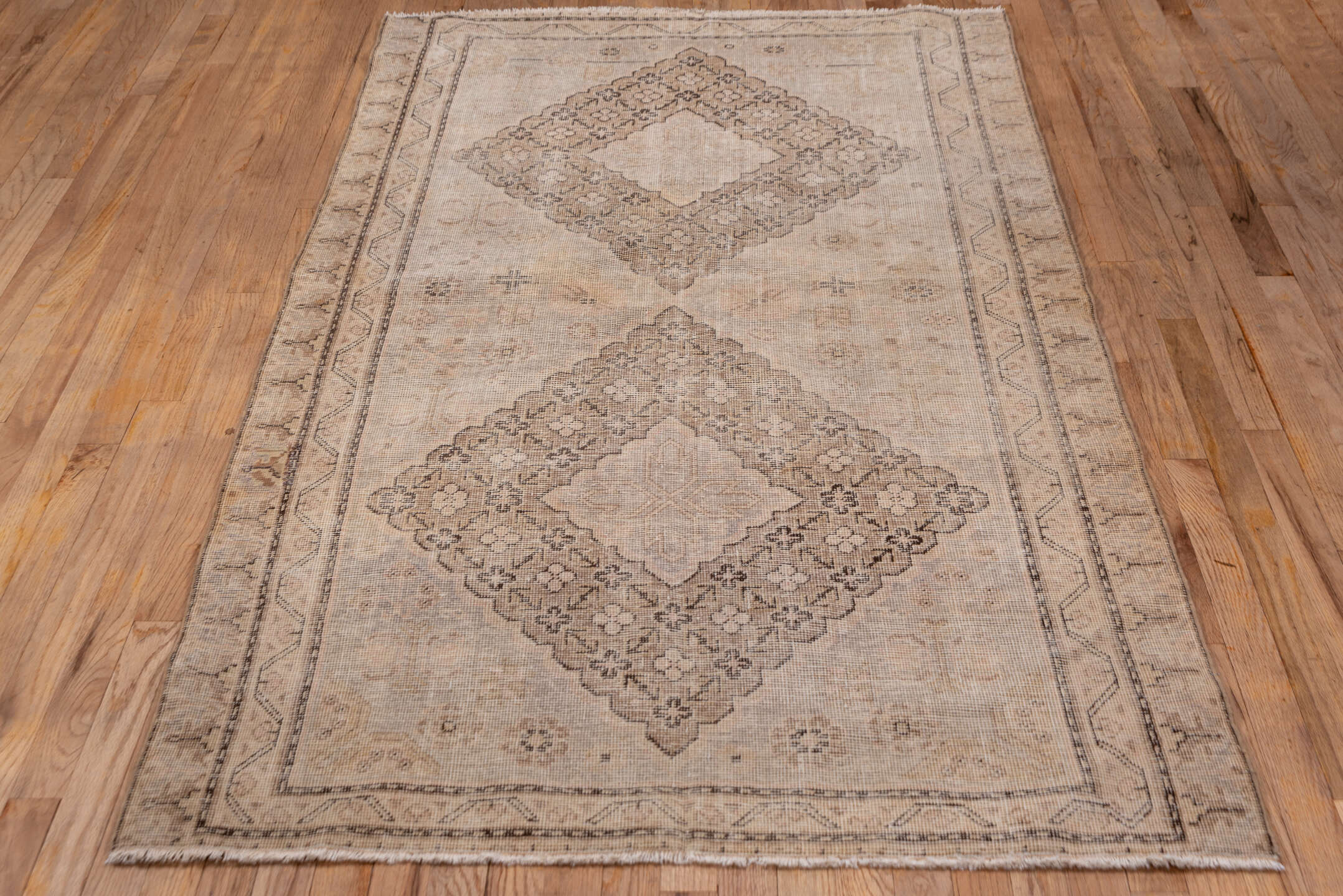4' x 7' one-of-a-kind handmade vintage Khotan rug. Color palette: brown, gray, light gray, off-white, orange, pink, snow