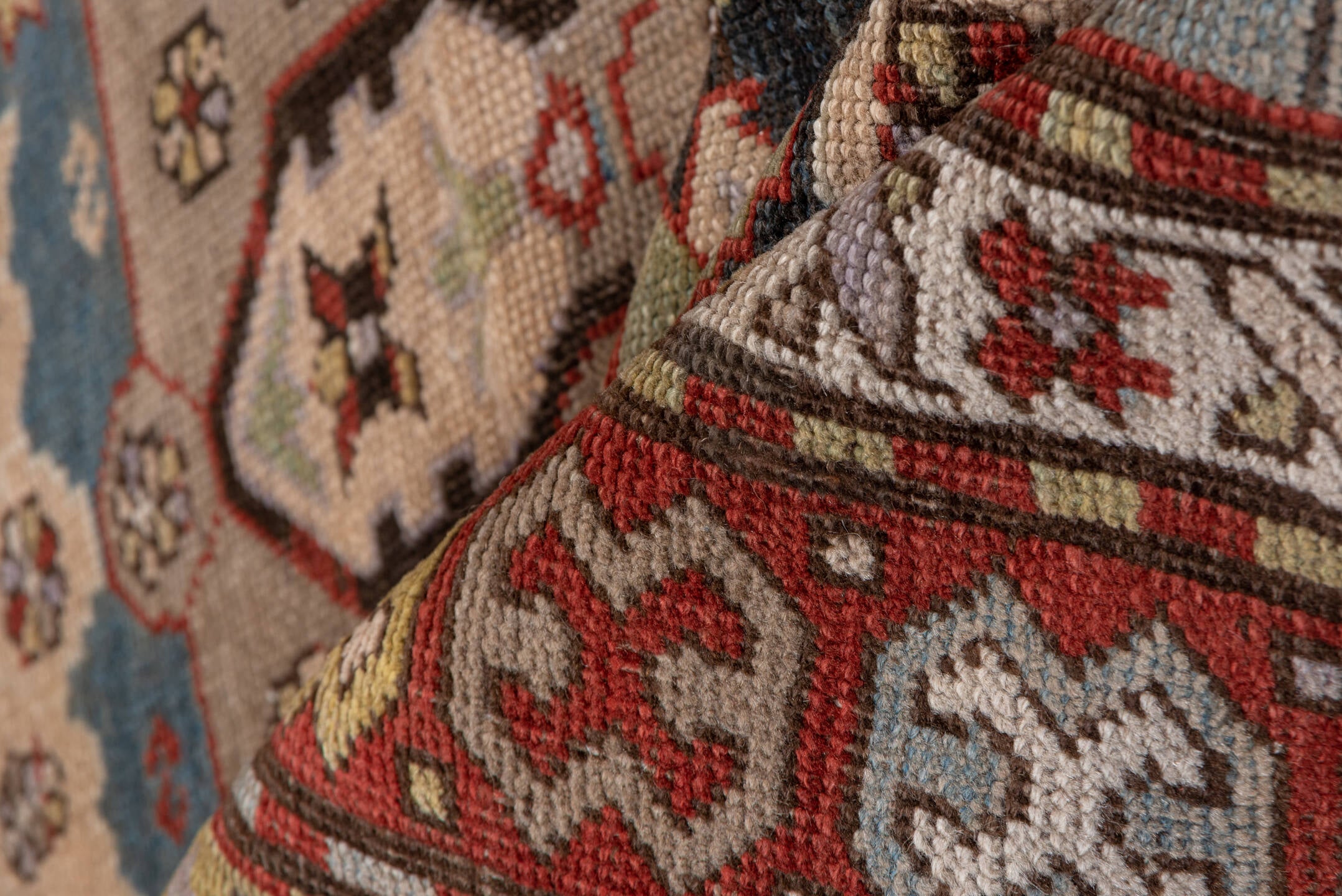 4' x 8' one-of-a-kind handmade antique Caucasian rug. Color palette: ivory, rust, brick, slate, sky_blue, camel, charcoal