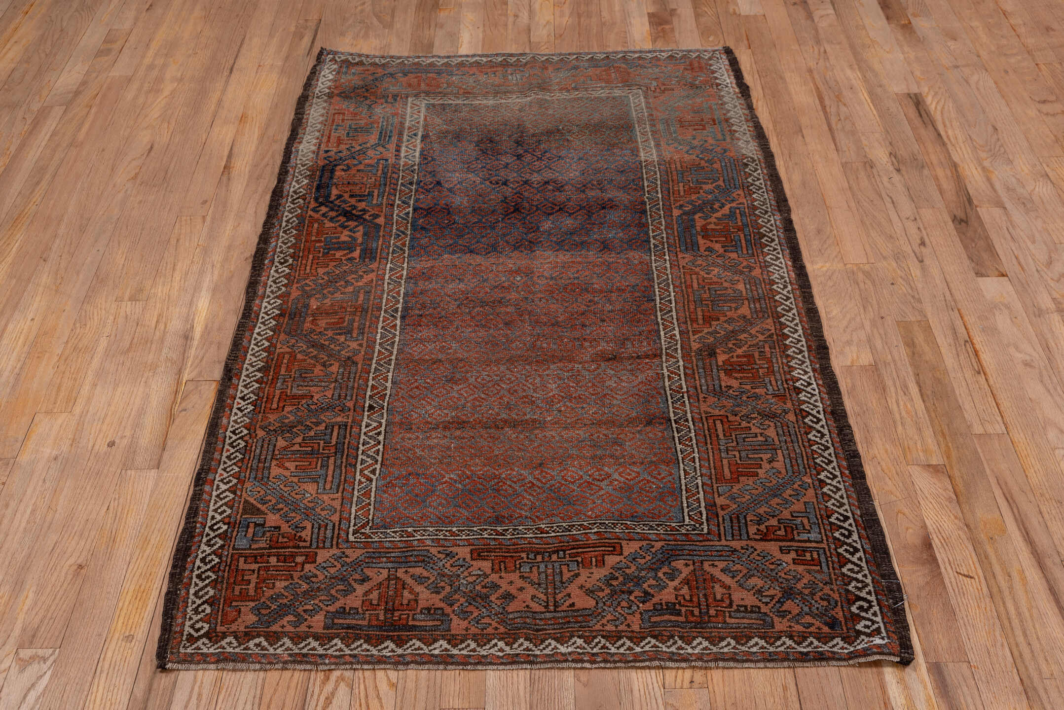 3' x 6' one-of-a-kind handmade antique Belouch small size rug. Color palette: rust, indigo, ivory, brown, charcoal