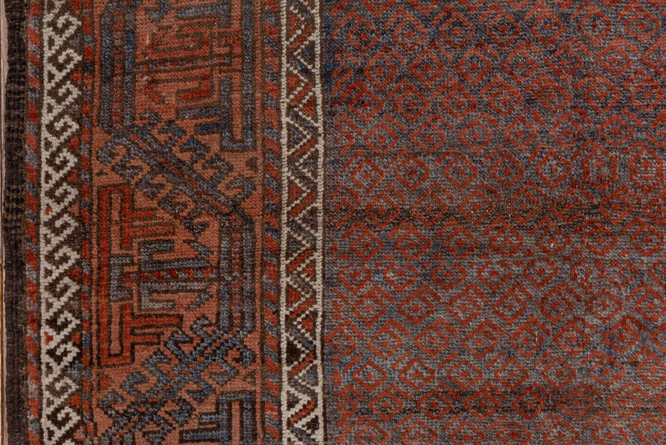 3' x 6' one-of-a-kind handmade antique Belouch small size rug. Color palette: rust, indigo, ivory, brown, charcoal