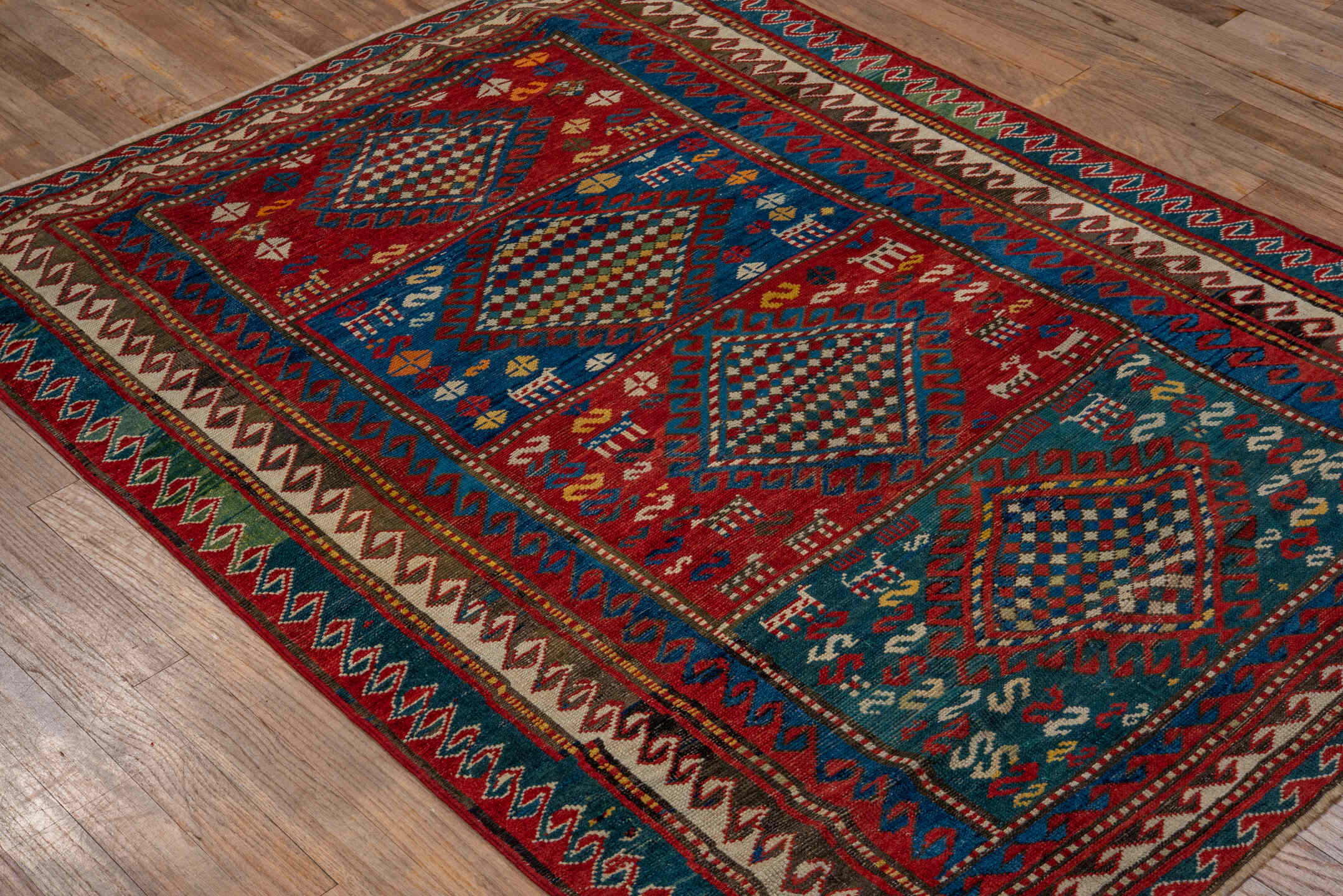 3' x 5' one-of-a-kind handmade antique Caucasian small size rug. Color palette: red, turquoise, ivory, blue, burgundy, camel