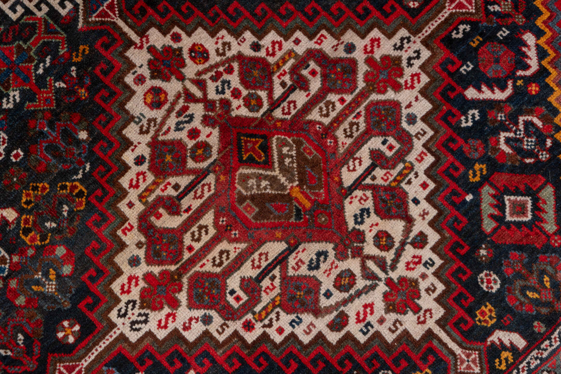 5' x 8' one-of-a-kind handmade antique Shiraz medium size rug. Color palette: red, navy, ivory, rust, burgundy, slate, gold