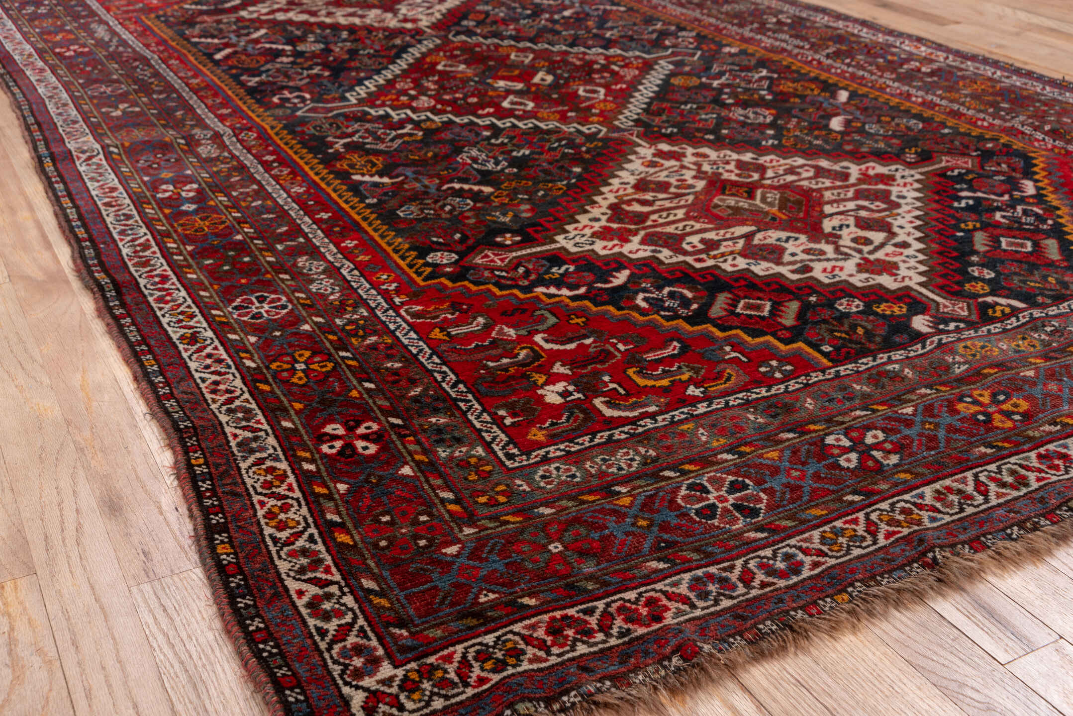 5' x 8' one-of-a-kind handmade antique Shiraz medium size rug. Color palette: red, navy, ivory, rust, burgundy, slate, gold