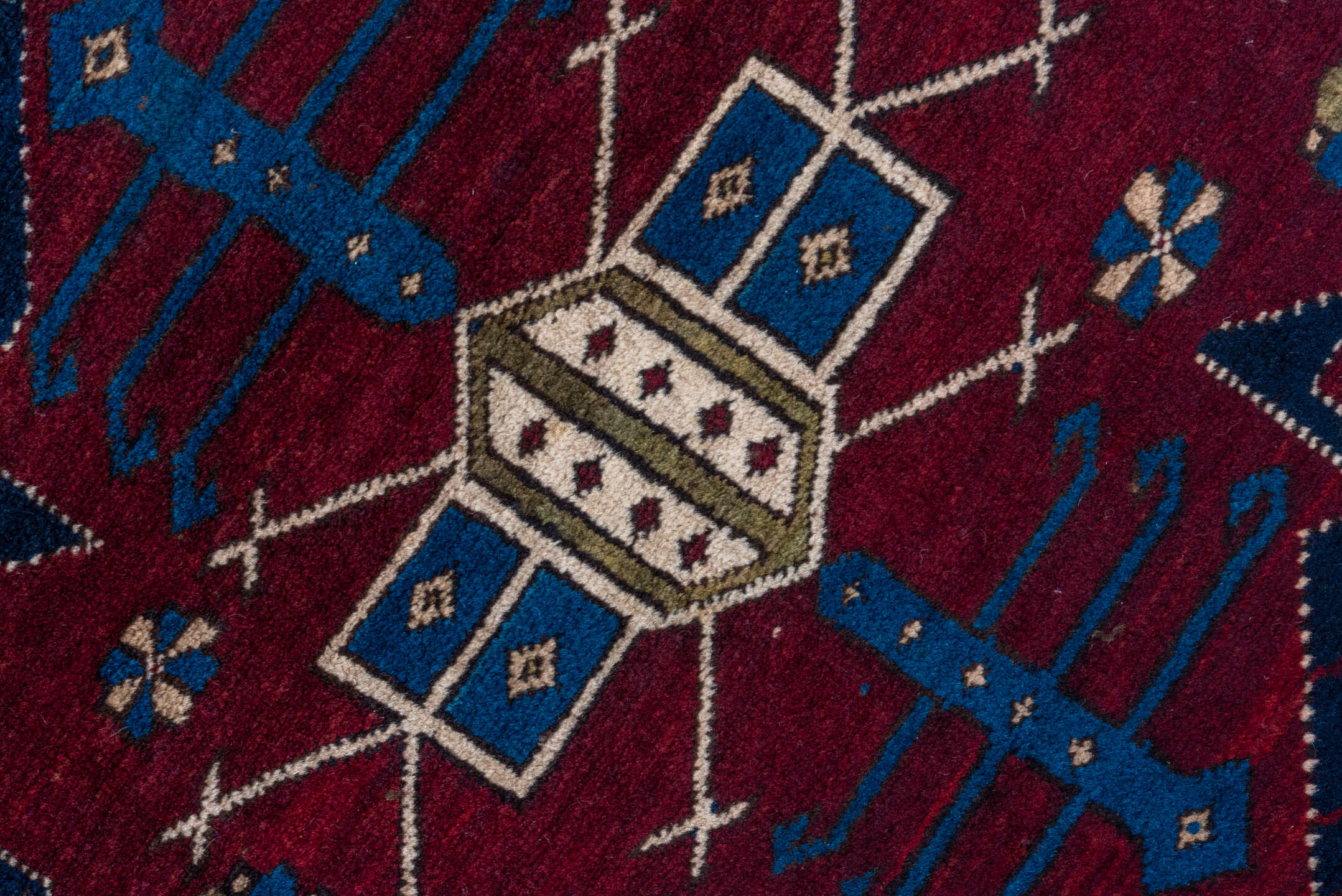 4' x 7' one-of-a-kind handmade antique Caucasian rug. Color palette: navy, crimson, ivory, cobalt, burgundy, camel, saffron