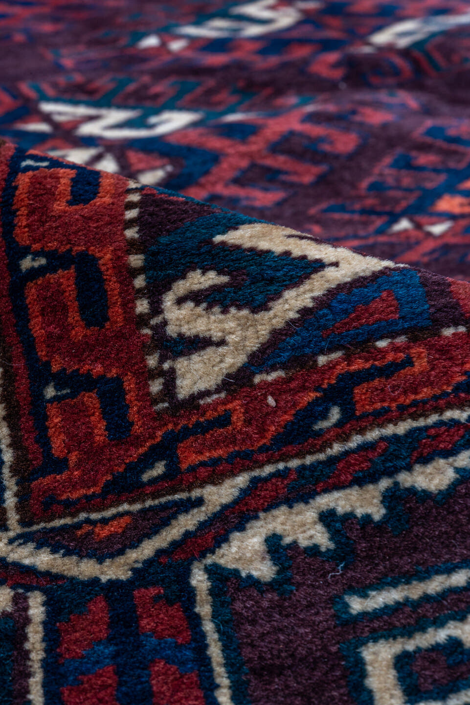 6' x 10' one-of-a-kind handmade vintage Yamoud large size rug. Color palette: burgundy, navy, rust, ivory, crimson, indigo