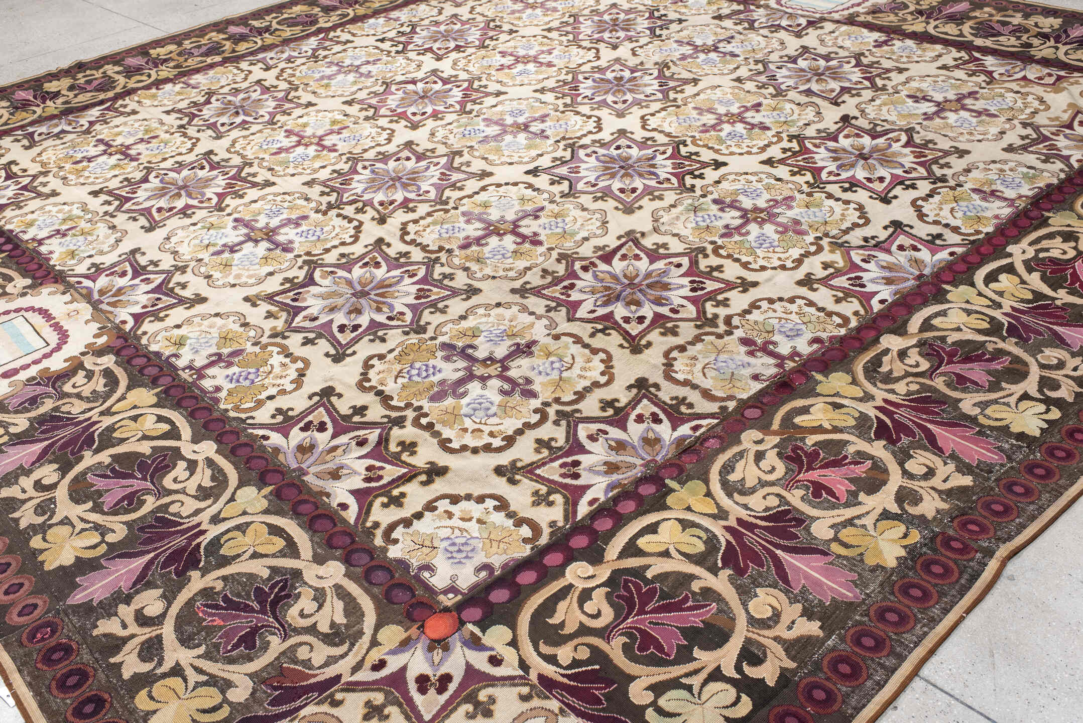 14' x 15' one-of-a-kind handmade antique Needlepoint oversize rug. Color palette: ivory, brown, burgundy, rose, taupe, sage