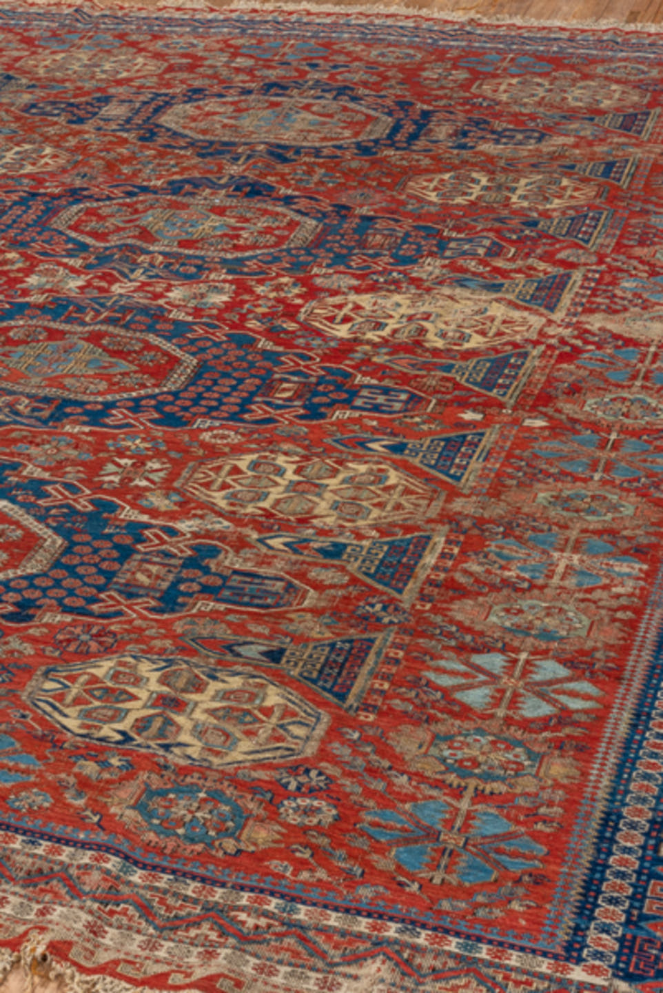 8' x 9' one-of-a-kind handmade antique Sumak rug. Color palette: rust, navy, ivory, sky blue, camel, crimson, terracotta