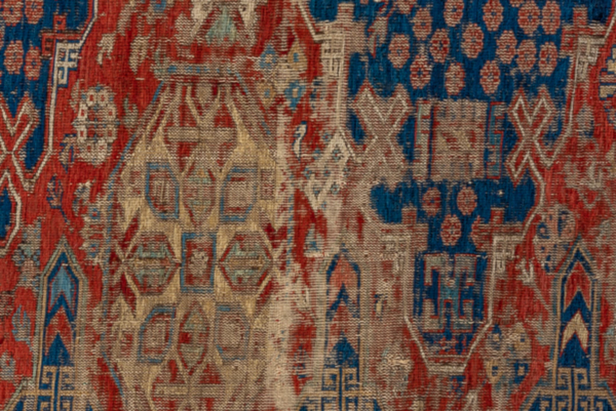 8' x 9' one-of-a-kind handmade antique Sumak rug. Color palette: rust, navy, ivory, sky blue, camel, crimson, terracotta