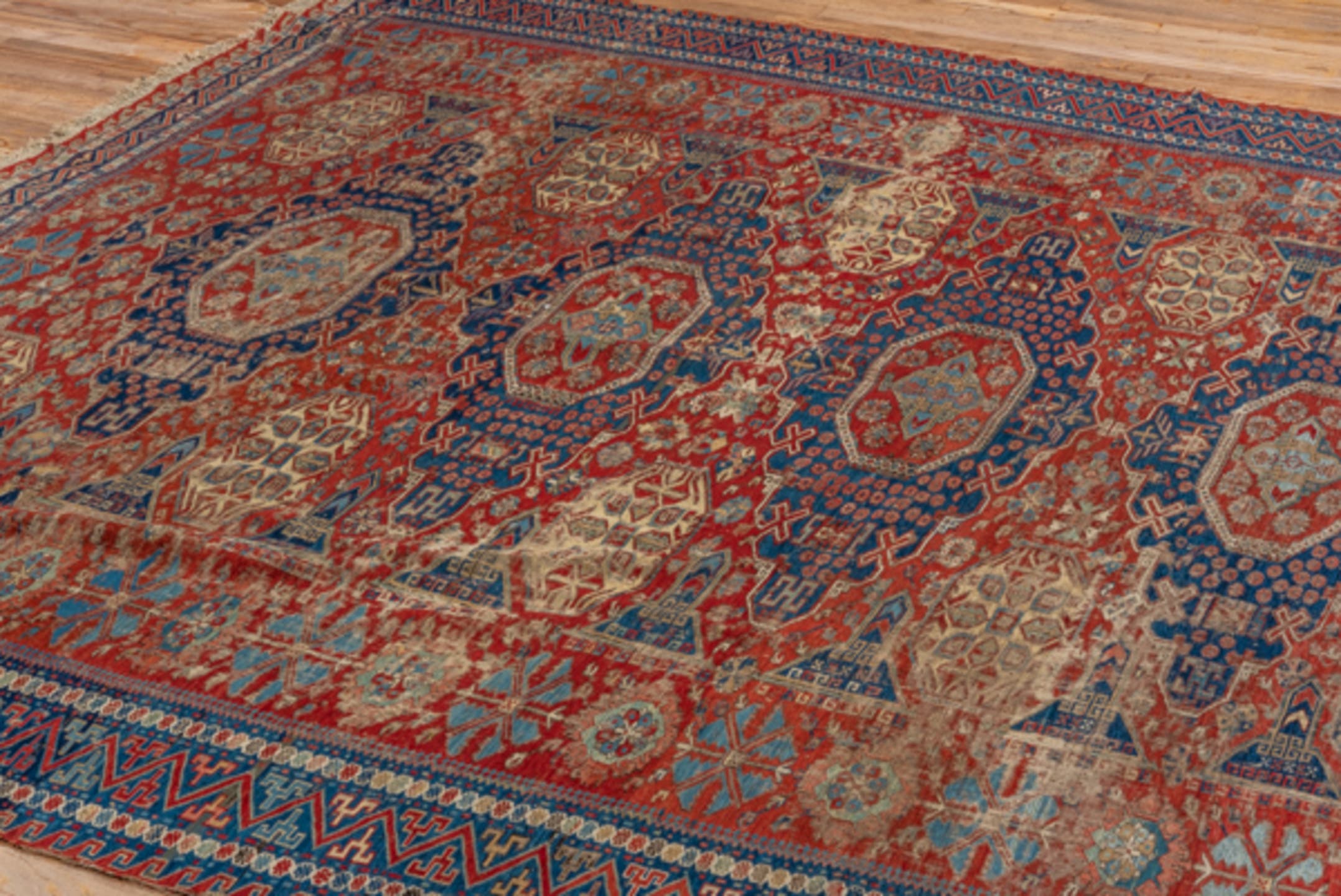 8' x 9' one-of-a-kind handmade antique Sumak rug. Color palette: rust, navy, ivory, sky blue, camel, crimson, terracotta