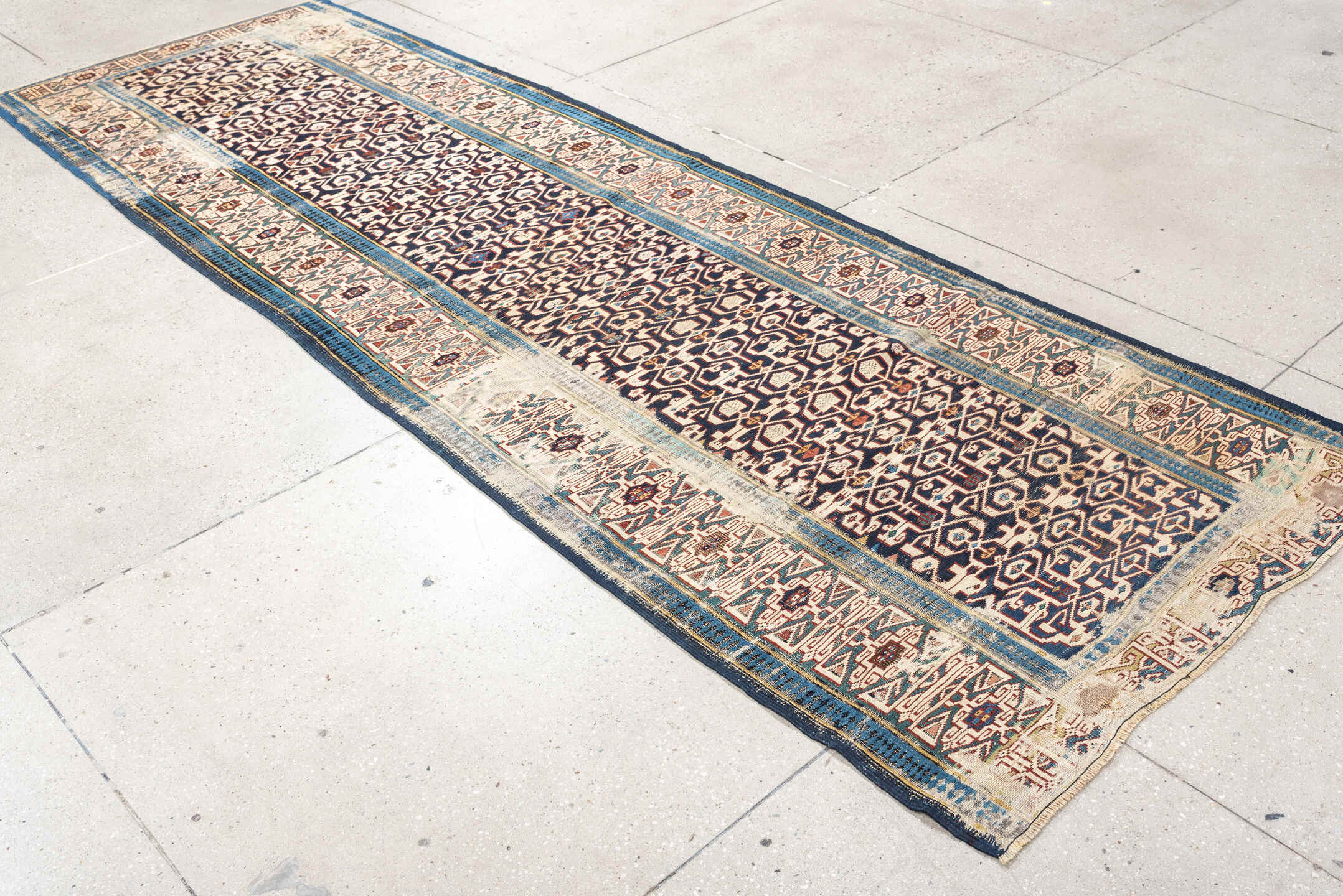 3' x 10' one-of-a-kind handmade antique Kuba runner rug. Color palette: indigo, ivory, rust, sky blue, camel, slate, purple
