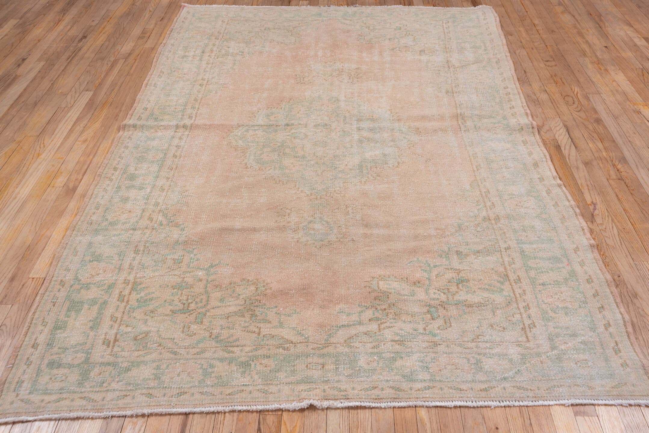 5' x 9' one-of-a-kind handmade vintage Sparta medium size rug. Color palette: blush, ivory, sage, cream, taupe, pink, green