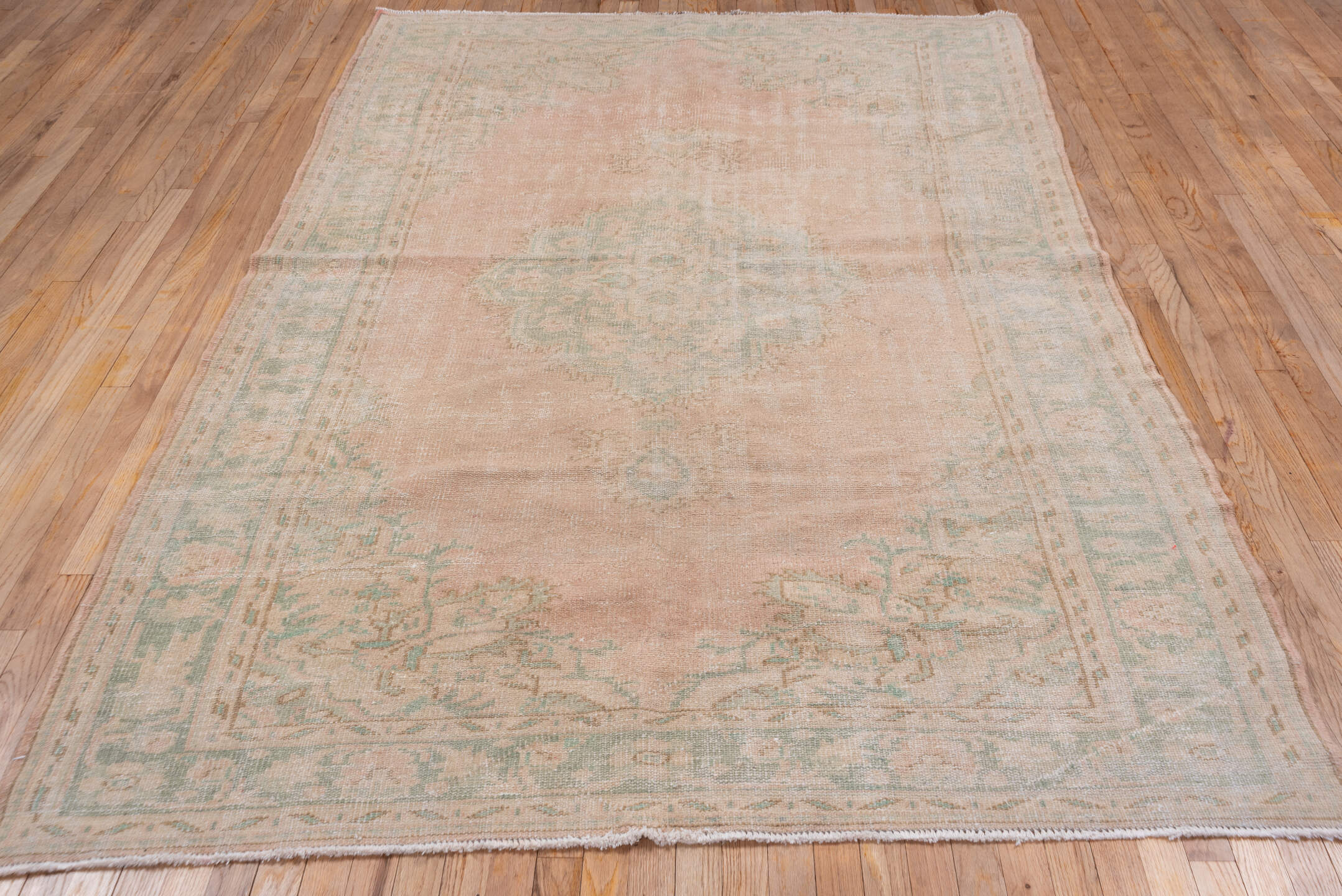 5' x 9' one-of-a-kind handmade vintage Sparta medium size rug. Color palette: blush, ivory, sage, cream, taupe, pink, green