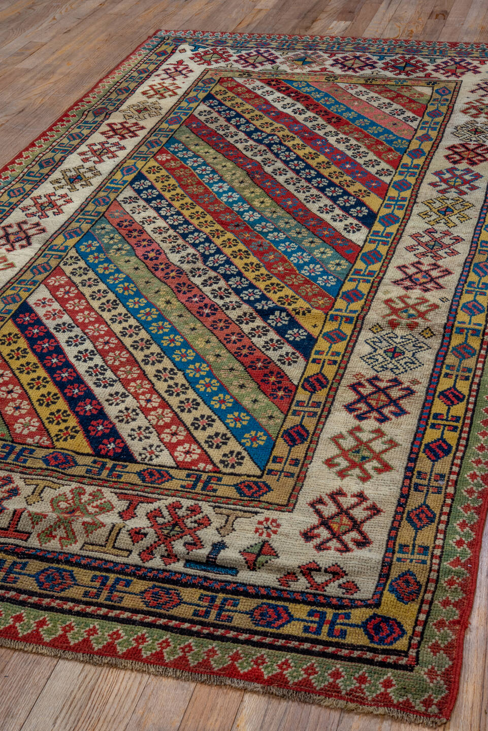 4' x 8' one-of-a-kind handmade antique Caucasian runner rug. Color palette: ivory, rust, indigo, camel, rose, navy, sage