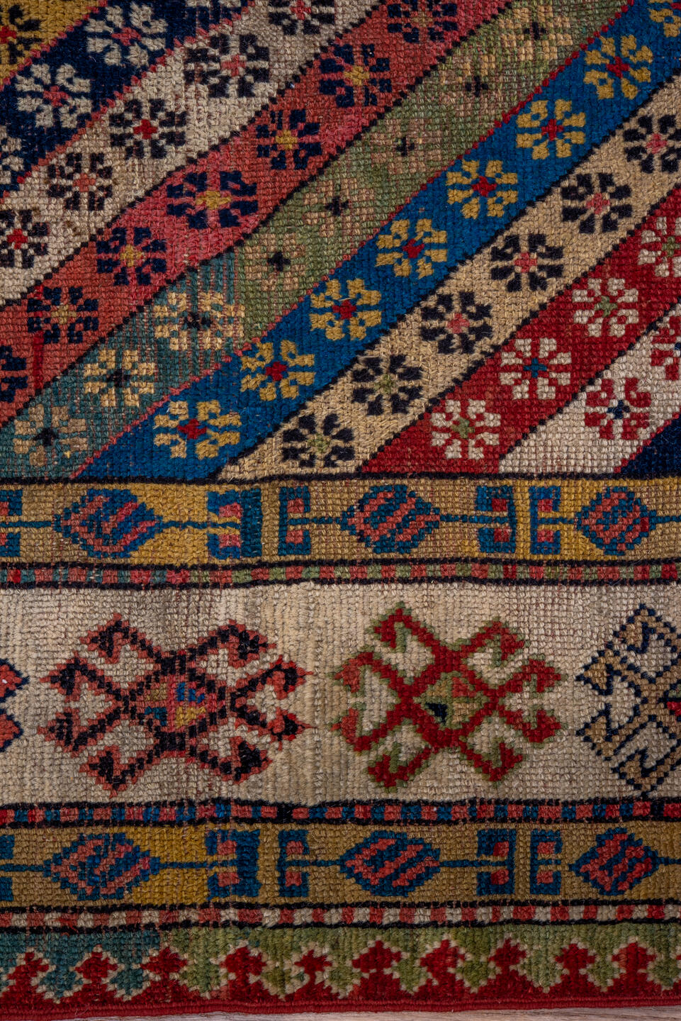4' x 8' one-of-a-kind handmade antique Caucasian runner rug. Color palette: ivory, rust, indigo, camel, rose, navy, sage