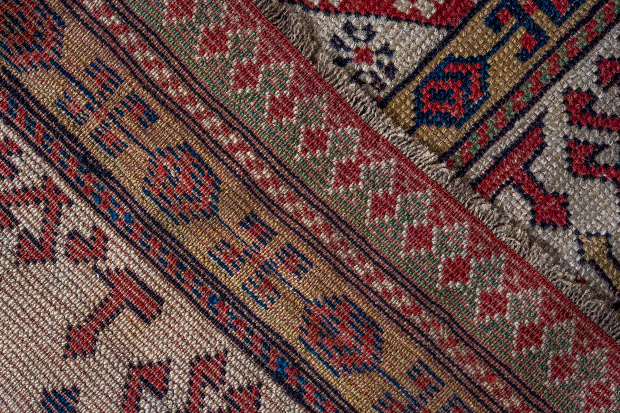 4' x 8' one-of-a-kind handmade antique Caucasian runner rug. Color palette: ivory, rust, indigo, camel, rose, navy, sage