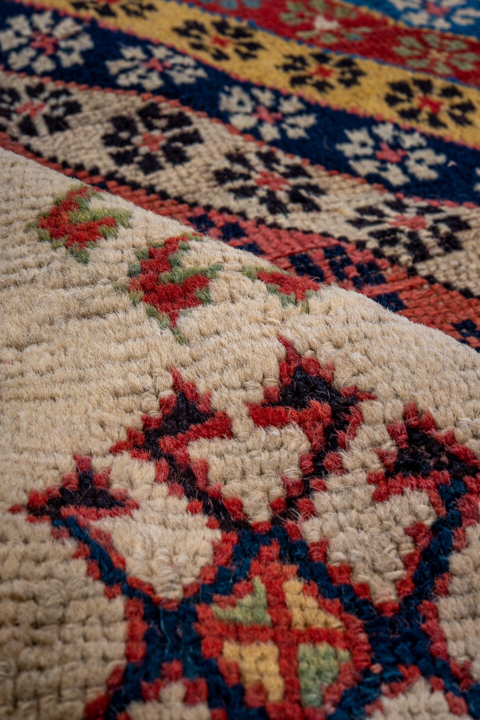 4' x 8' one-of-a-kind handmade antique Caucasian runner rug. Color palette: ivory, rust, indigo, camel, rose, navy, sage