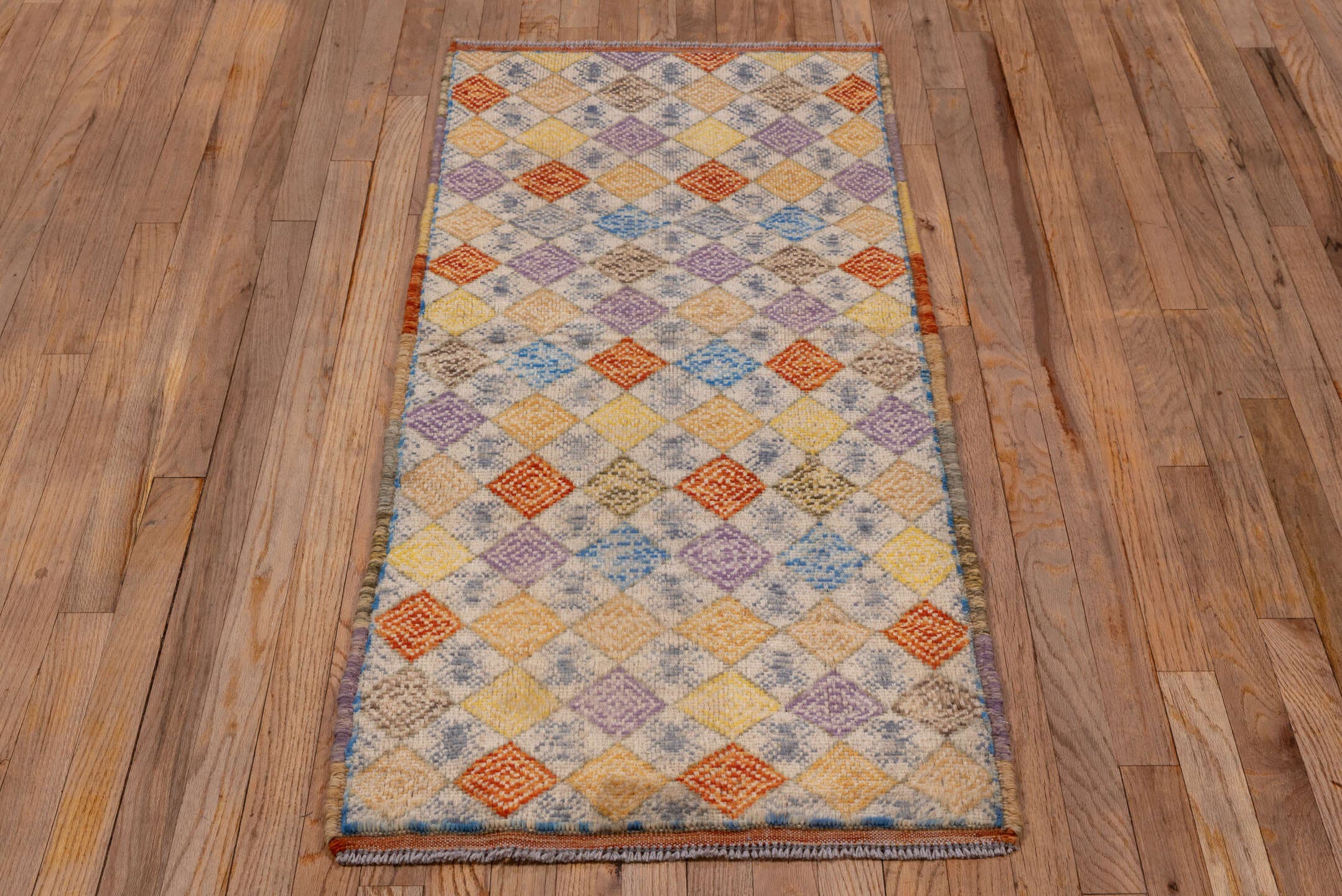 2' x 5' one-of-a-kind handmade vintage Gabbe small size rug. Color palette: ivory, gold, lavender, rust, sky blue, camel