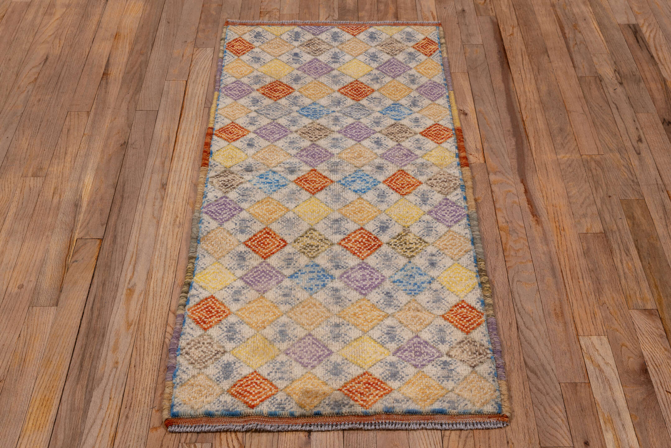 2' x 5' one-of-a-kind handmade vintage Gabbe small size rug. Color palette: ivory, gold, lavender, rust, sky blue, camel
