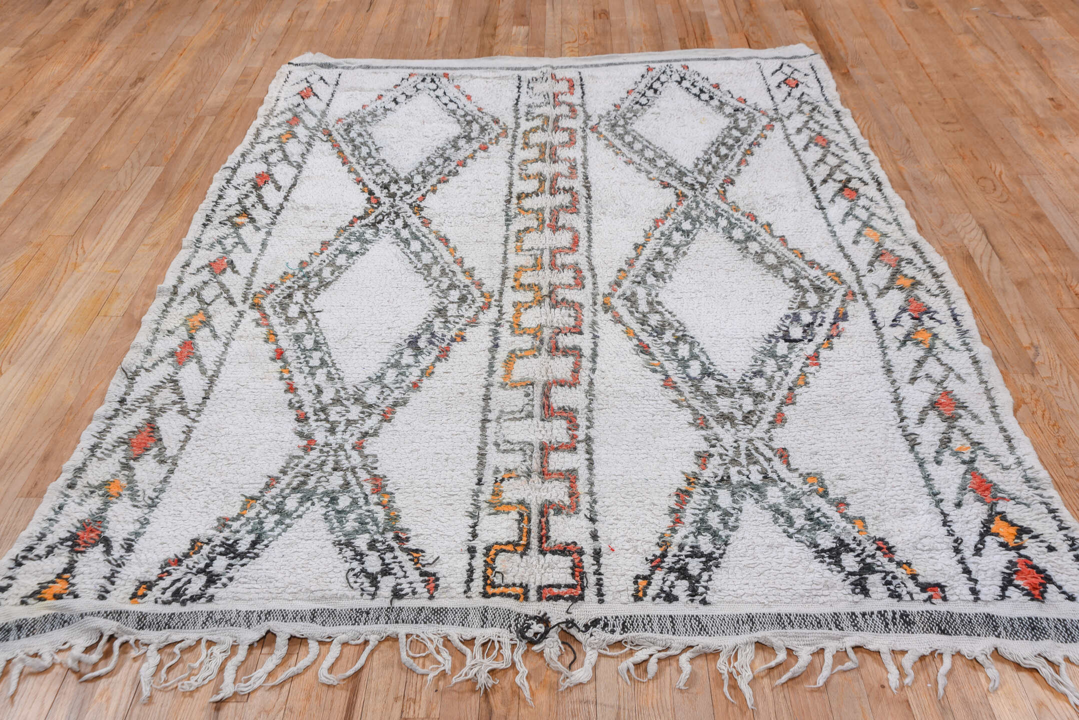 5' x 8' one-of-a-kind handmade vintage Moroccan medium size rug. Color palette: ivory, charcoal, rust, saffron, gray, black