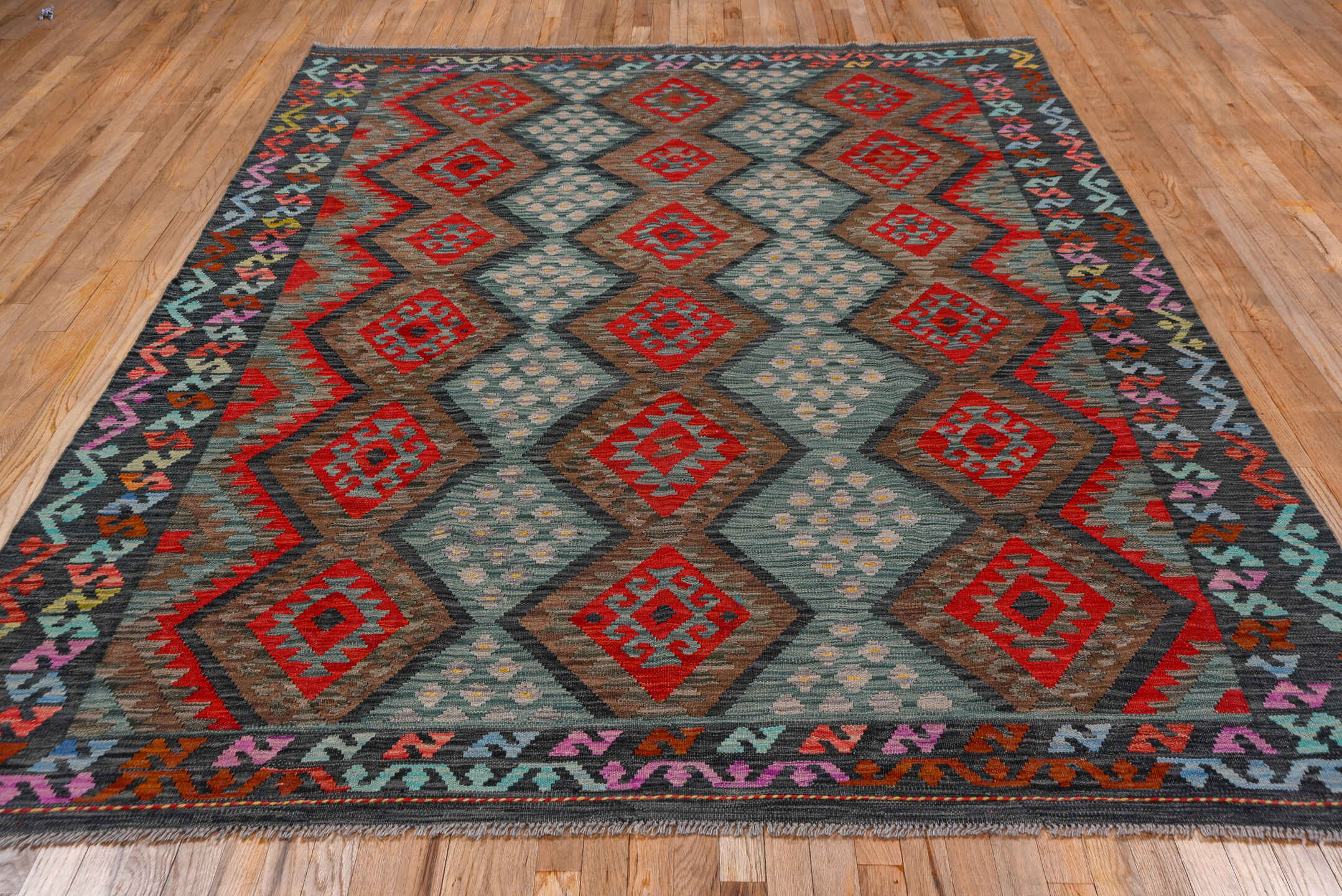 7' x 9' one-of-a-kind handmade vintage Kilim rug. Color palette: aqua, charcoal, crimson, taupe, coral, lavender, ivory