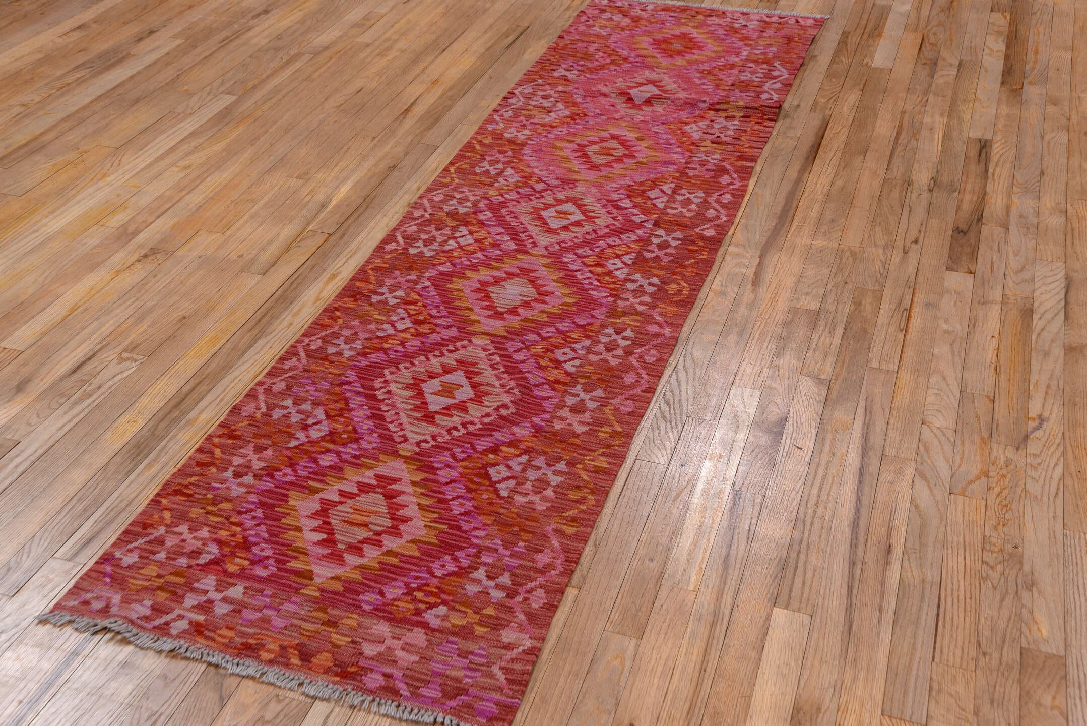 2' x 9' one-of-a-kind handmade vintage Kilim runner rug. Color palette: rose, pink, rust, magenta, terra cotta, ivory