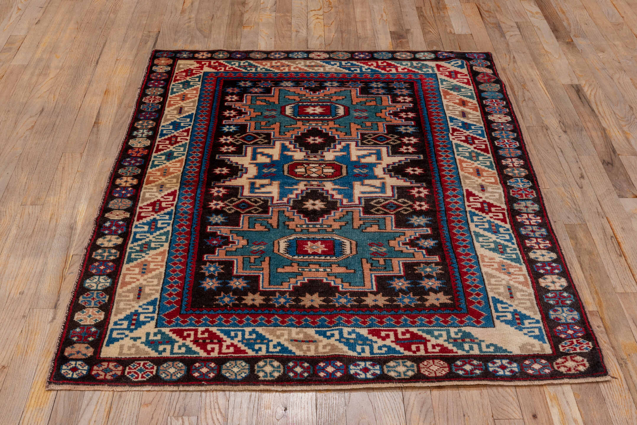 3' x 5' one-of-a-kind handmade antique Caucasian small size rug. Color palette: ivory, brown, sky blue, crimson, navy, rose