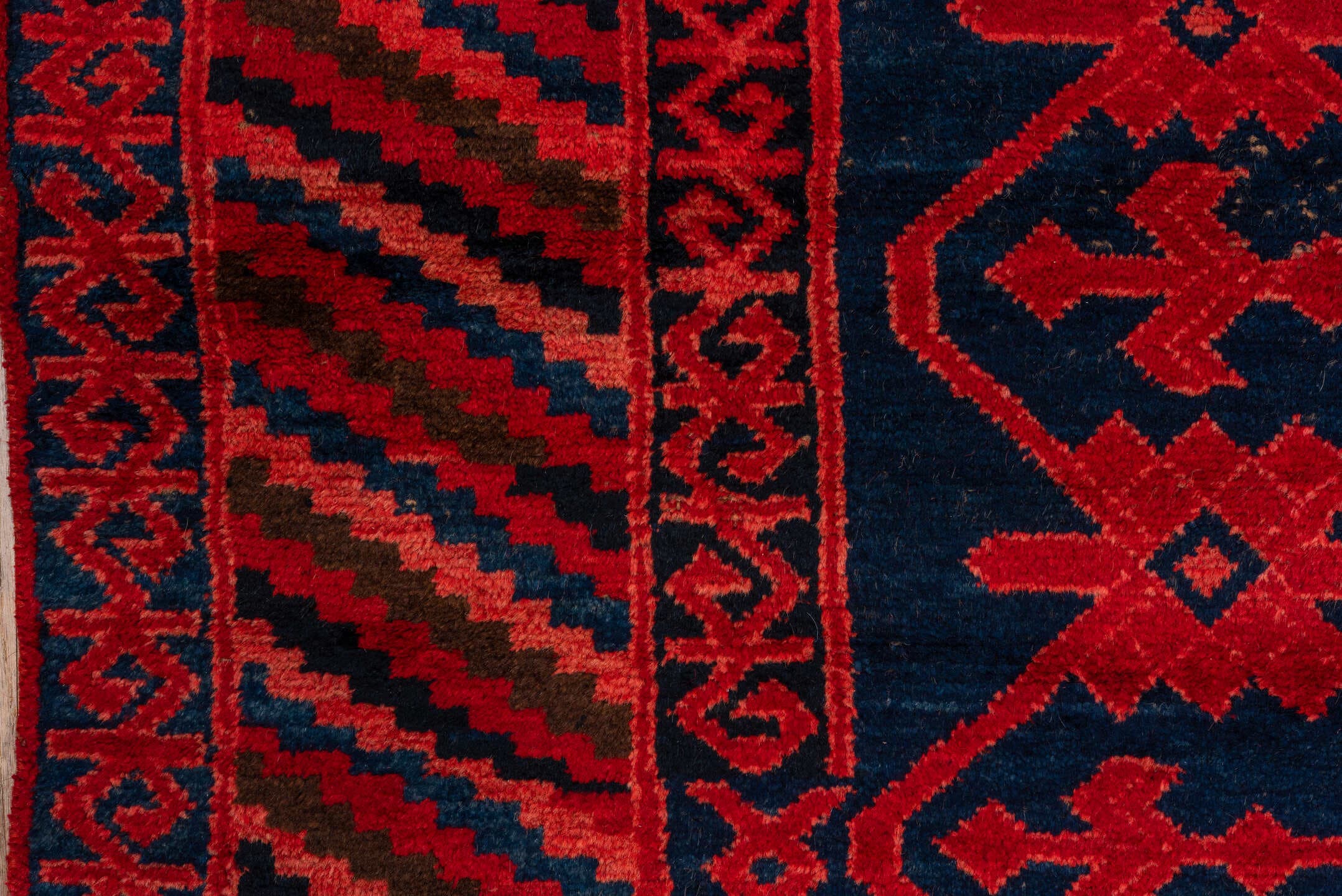 4' x 10' one-of-a-kind handmade antique Khotan runner rug. Color palette: crimson, navy, burgundy, indigo, red, blue, purple