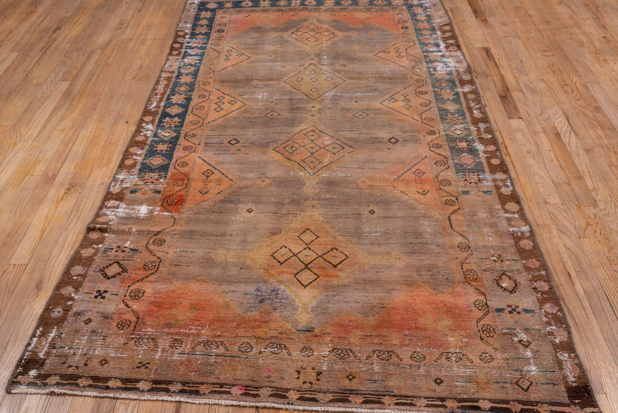 4' x 9' one-of-a-kind handmade vintage Distressed runner rug. Color palette: taupe, terra cotta, brown, charcoal, camel