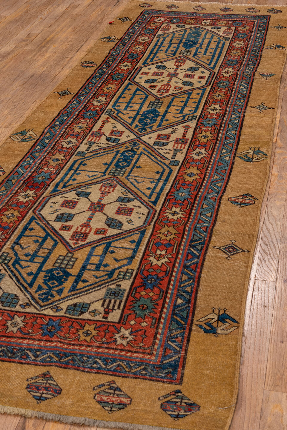 3' x 10' one-of-a-kind handmade antique Sarab runner rug. Color palette: camel, indigo, ivory, rust, terra cotta, navy