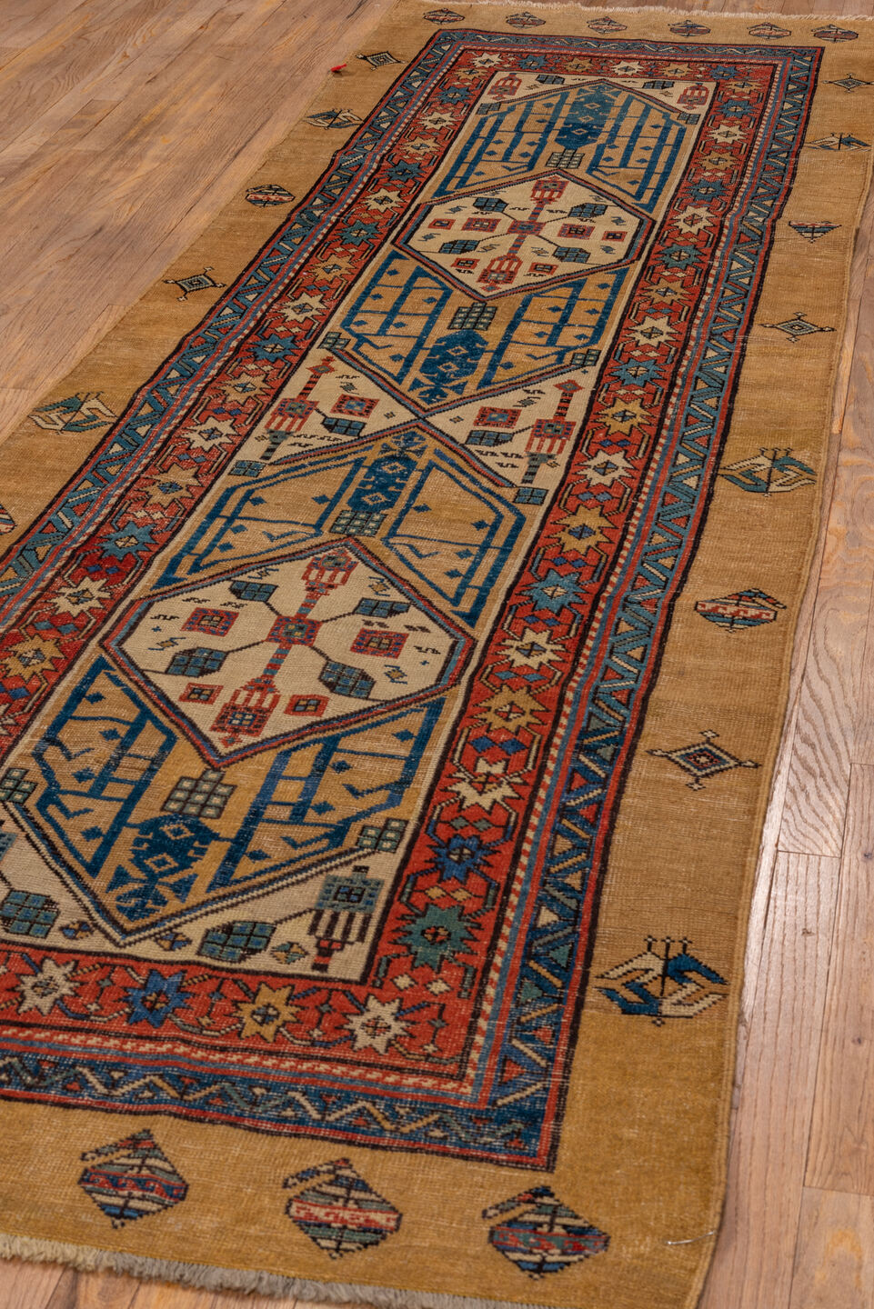 3' x 10' one-of-a-kind handmade antique Sarab runner rug. Color palette: camel, indigo, ivory, rust, terra cotta, navy