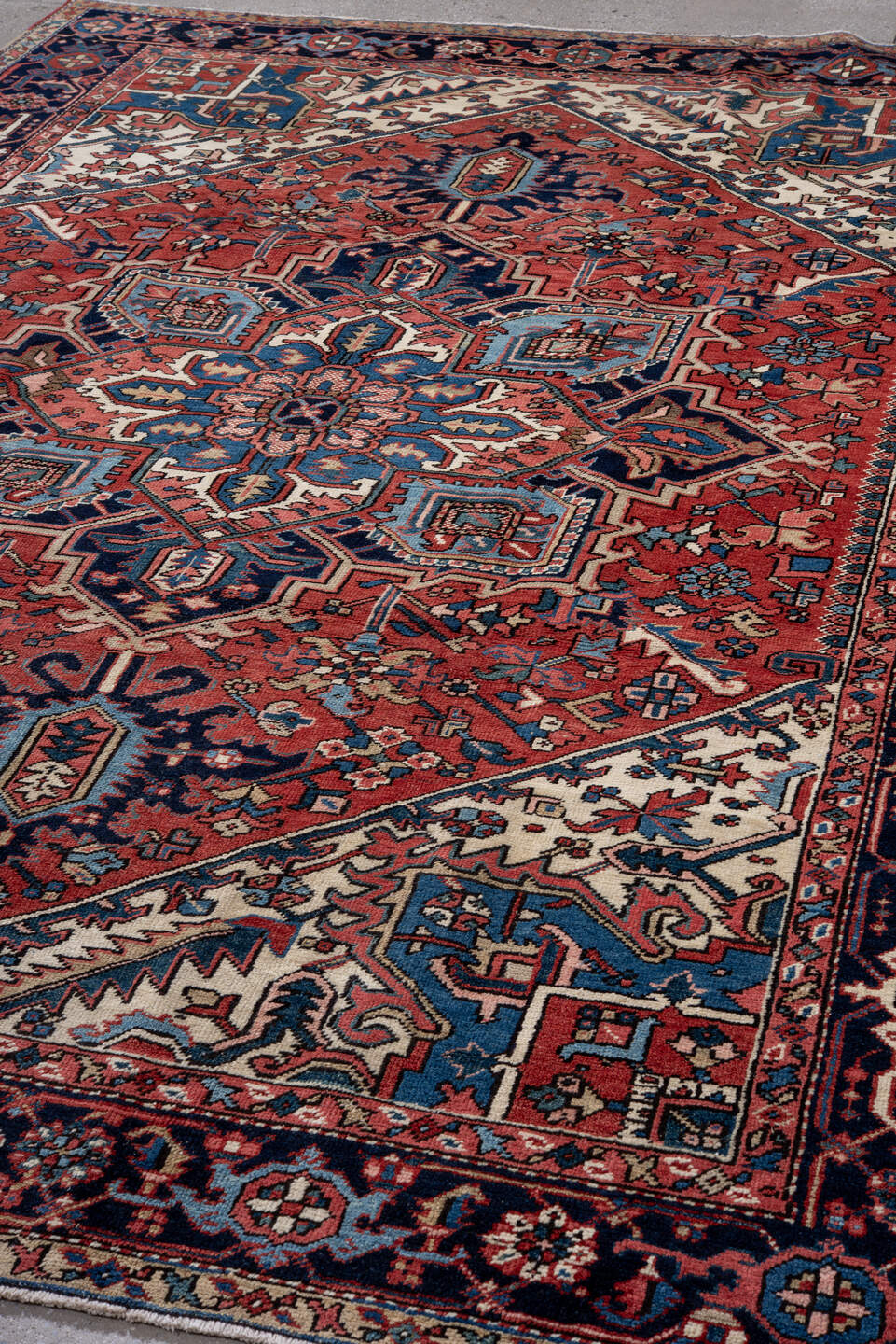 7' x 10' one-of-a-kind handmade antique Heriz large size rug. Color palette: rust, navy, ivory, sky_blue, coral, camel