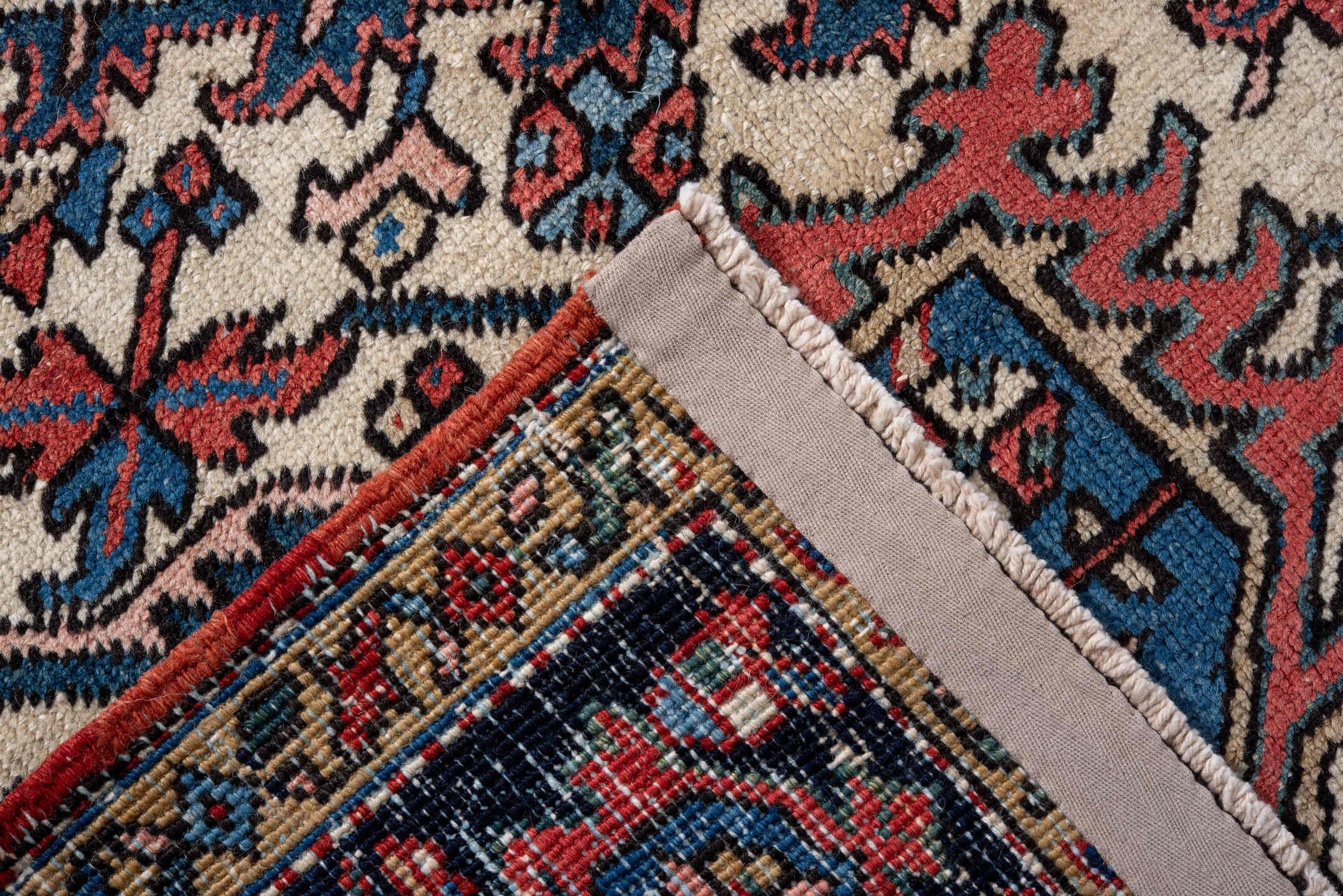 7' x 10' one-of-a-kind handmade antique Heriz large size rug. Color palette: rust, navy, ivory, sky_blue, coral, camel