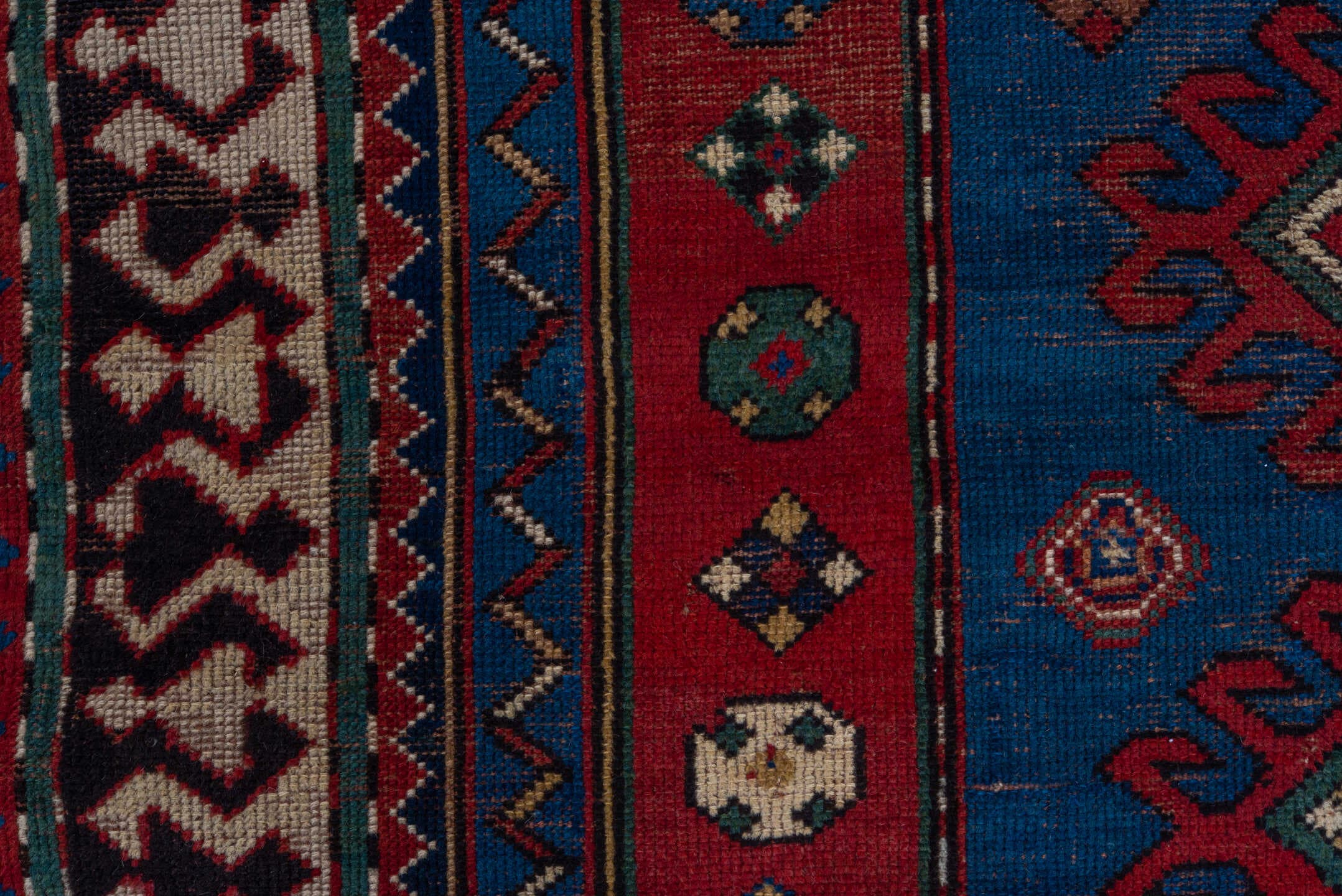 3' x 6' one-of-a-kind handmade antique Kazak small size rug. Color palette: blue, rust, ivory, navy, crimson, gold, teal