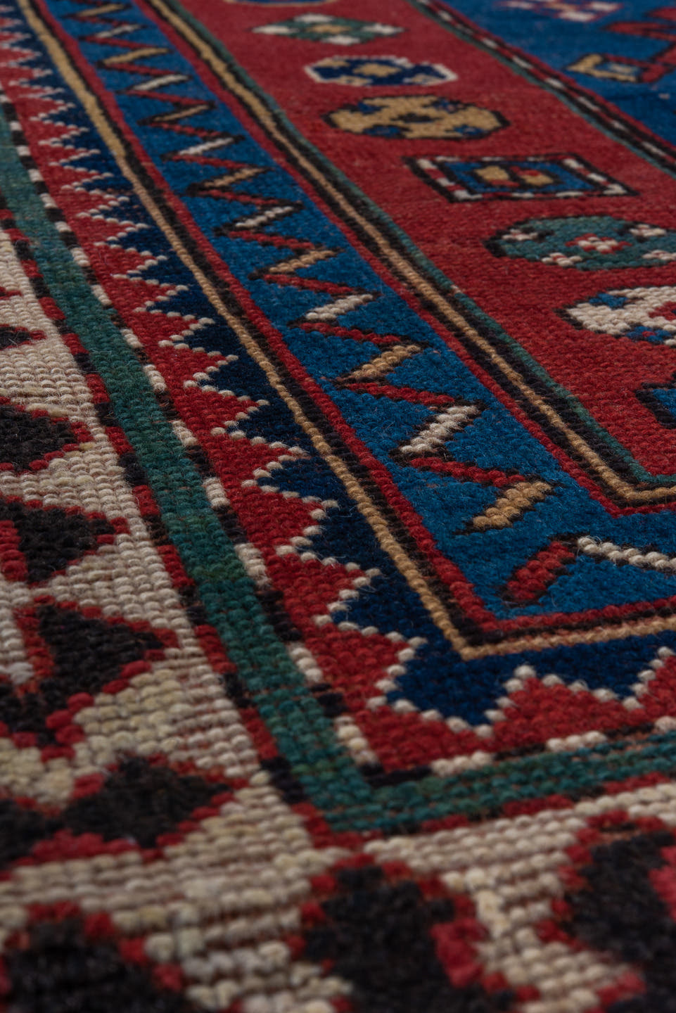 3' x 6' one-of-a-kind handmade antique Kazak small size rug. Color palette: blue, rust, ivory, navy, crimson, gold, teal