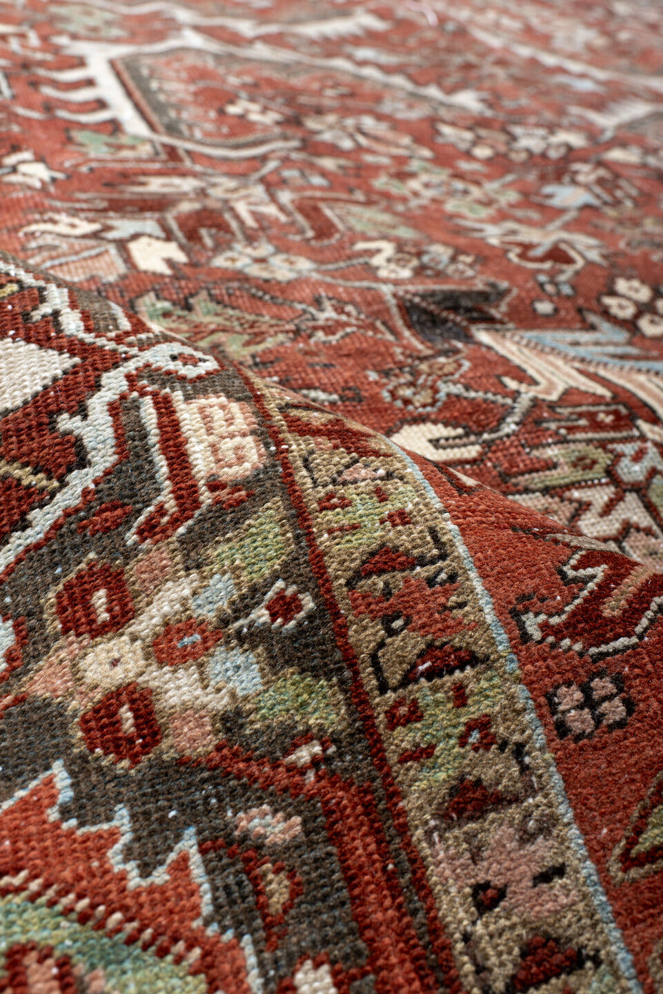 7' x 10' one-of-a-kind handmade antique Heriz large size rug. Color palette: rust, charcoal, ivory, sky_blue, sage, taupe