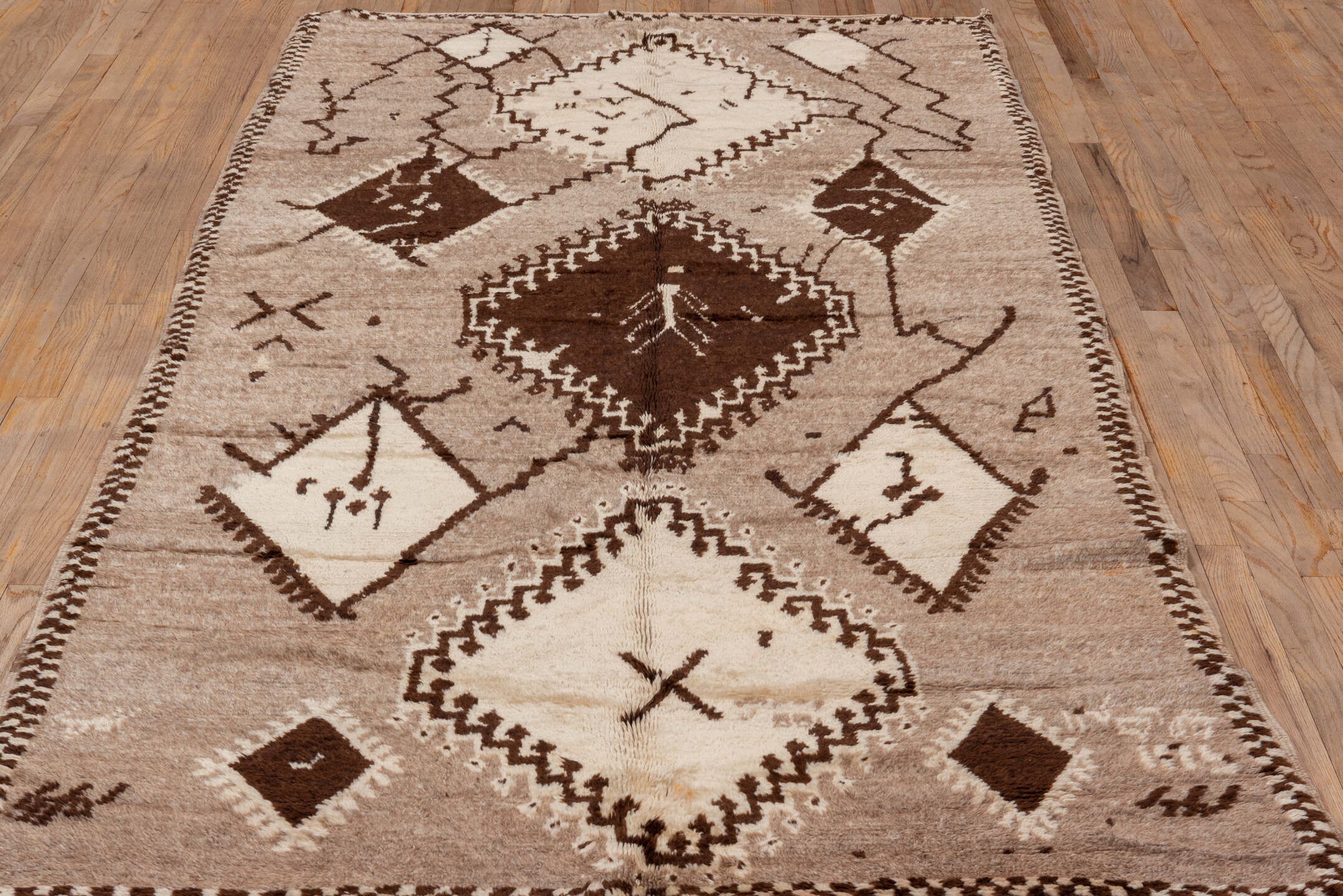 4' x 9' one-of-a-kind handmade vintage Moroccan runner rug. Color palette: black, brown, gray, light gray, off-white, orange