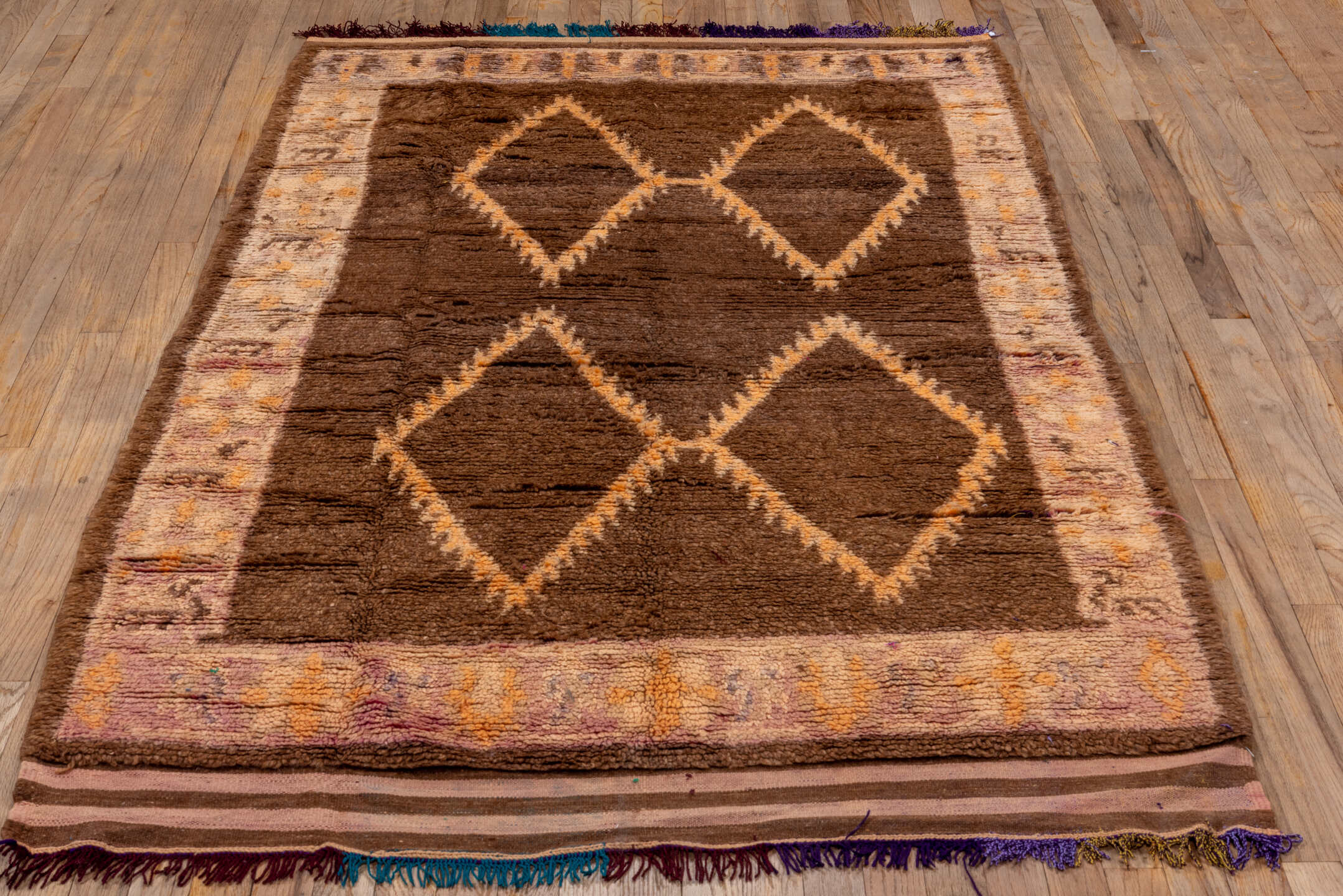 4' x 7' one-of-a-kind handmade vintage Moroccan rug. Color palette: brown, ivory, blush, taupe, charcoal, teal, purple, gold