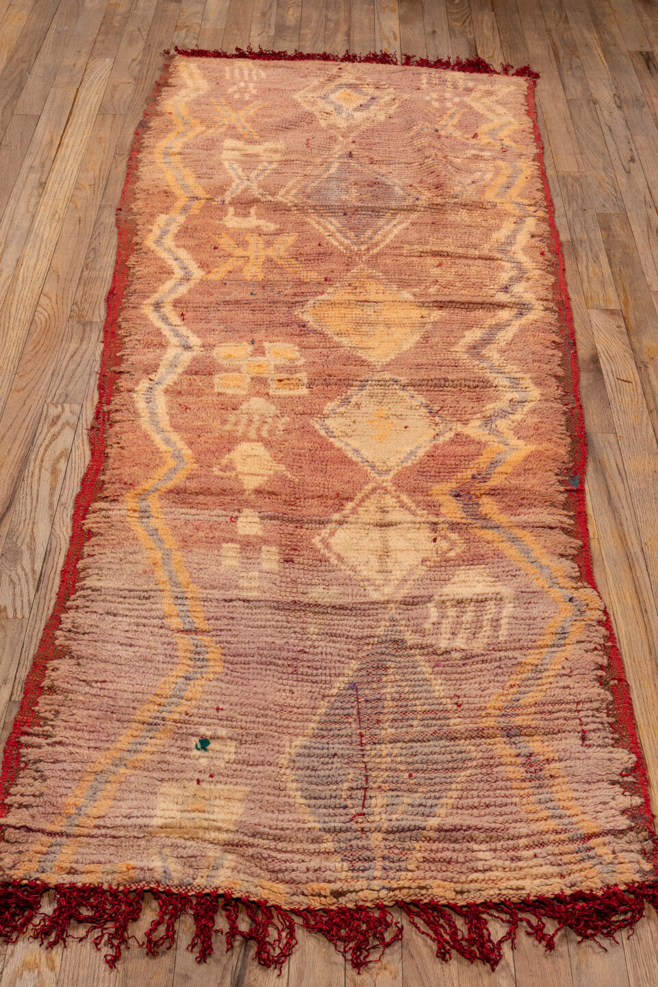 2' x 7' one-of-a-kind handmade vintage Moroccan runner rug. Color palette: brown, orange, pink, red